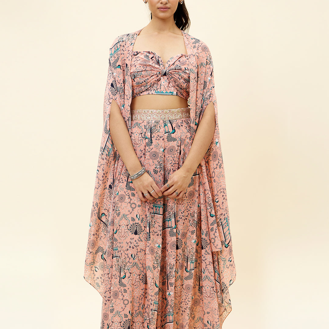 PINK MOR JAAL PRINT BIKINI BUSTIER TEAMED WITH BOX PLEATED PANTS AND A CAPE