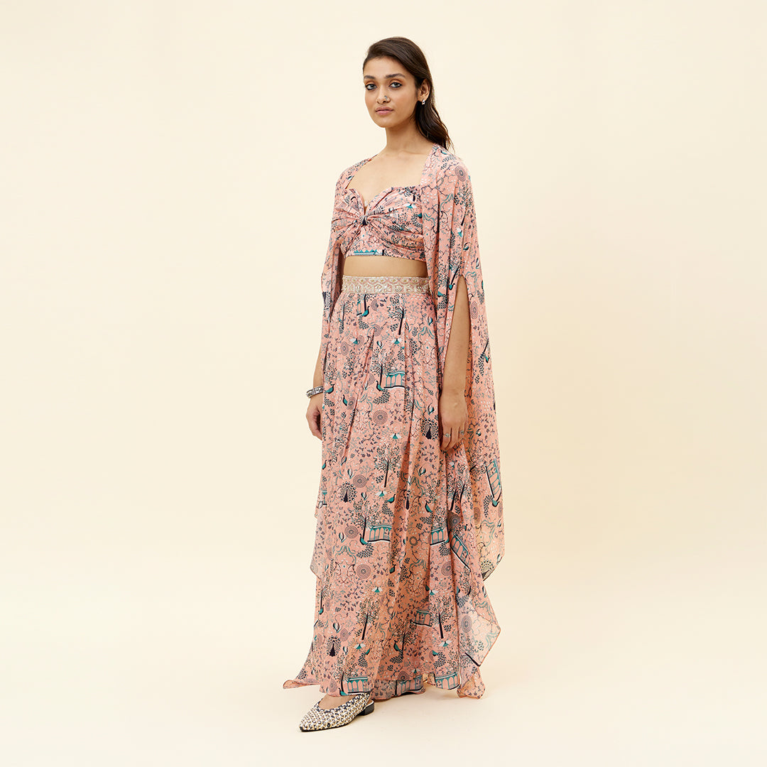 PINK MOR JAAL PRINT BIKINI BUSTIER TEAMED WITH BOX PLEATED PANTS AND A CAPE