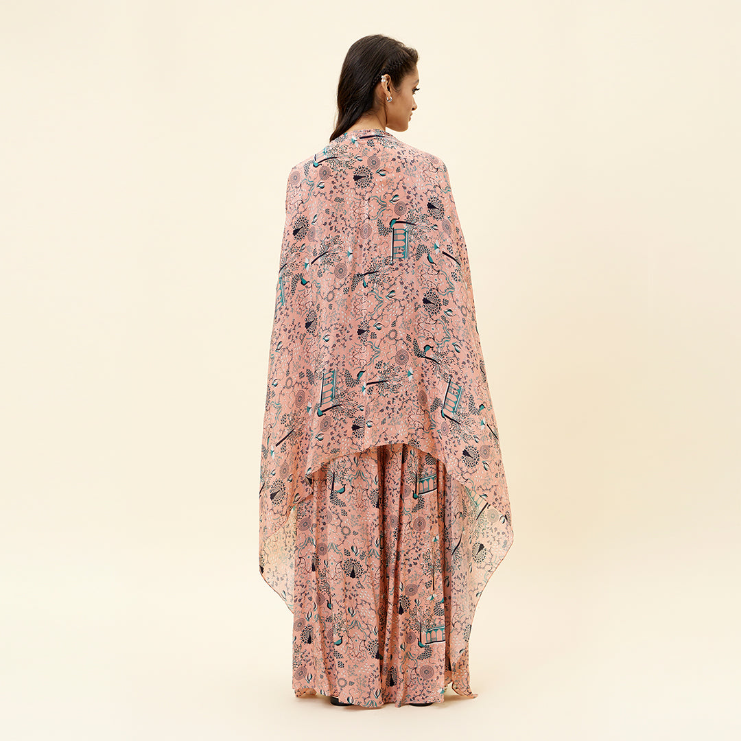 PINK MOR JAAL PRINT BIKINI BUSTIER TEAMED WITH BOX PLEATED PANTS AND A CAPE