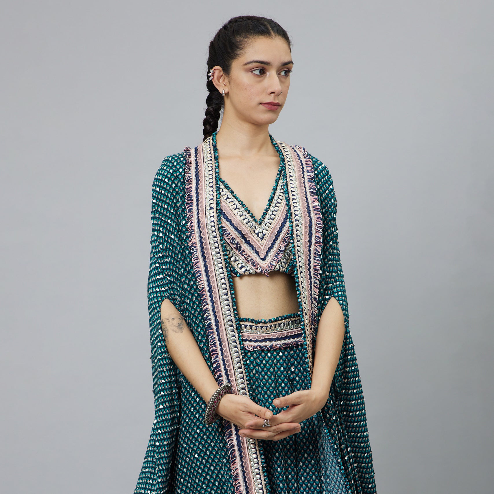 TEXTURED CROP TOP TEAMED WITH EMBELLISHED BLUE BUTTI PRINT BOX PLEAT PANTS HIGHLIGHTED CAPE