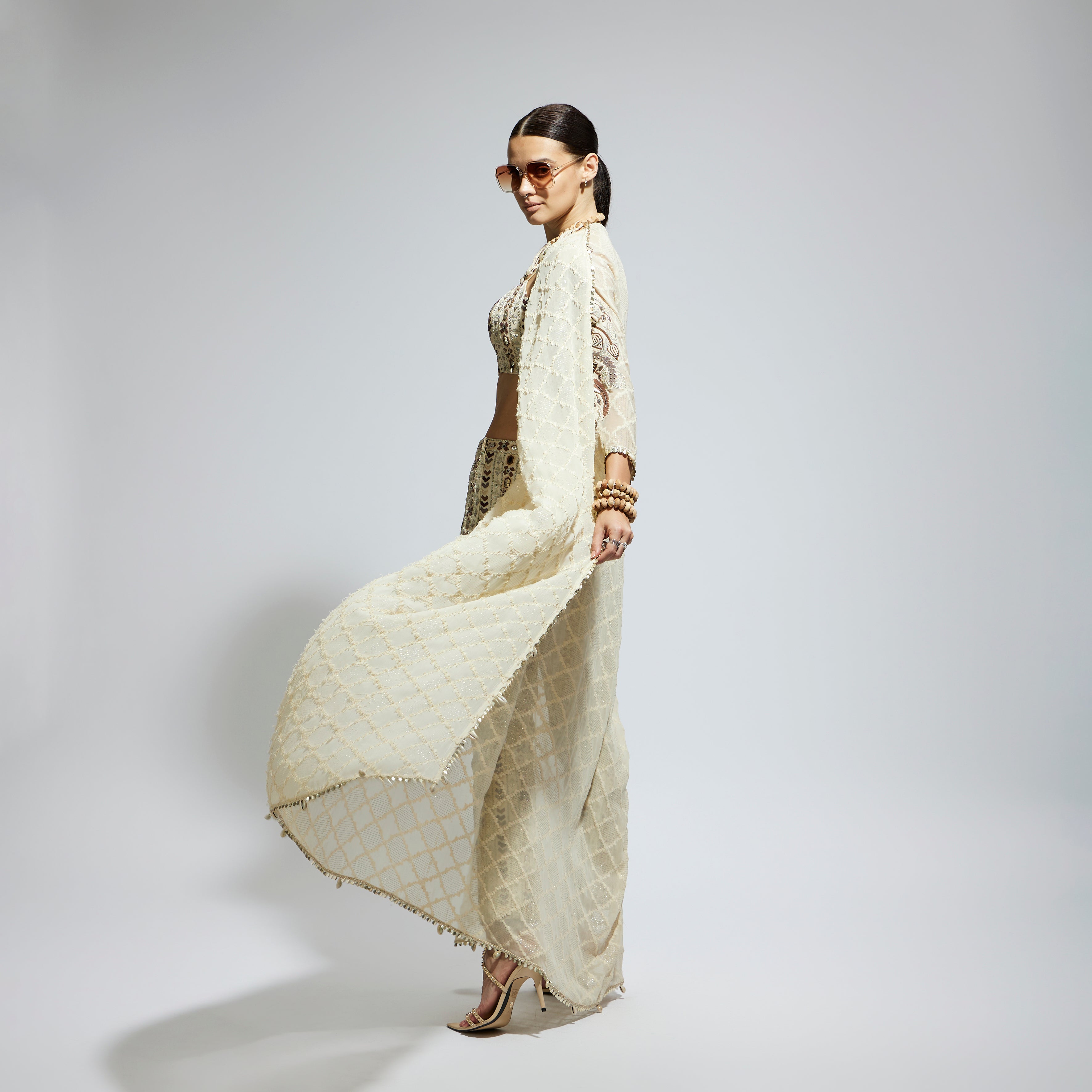 SAMSARA: IVORY AZTEC EMBELLISHED CAPE PAIRED WITH HEAVILY EMBELLISHED BUSTIER AND PANTS