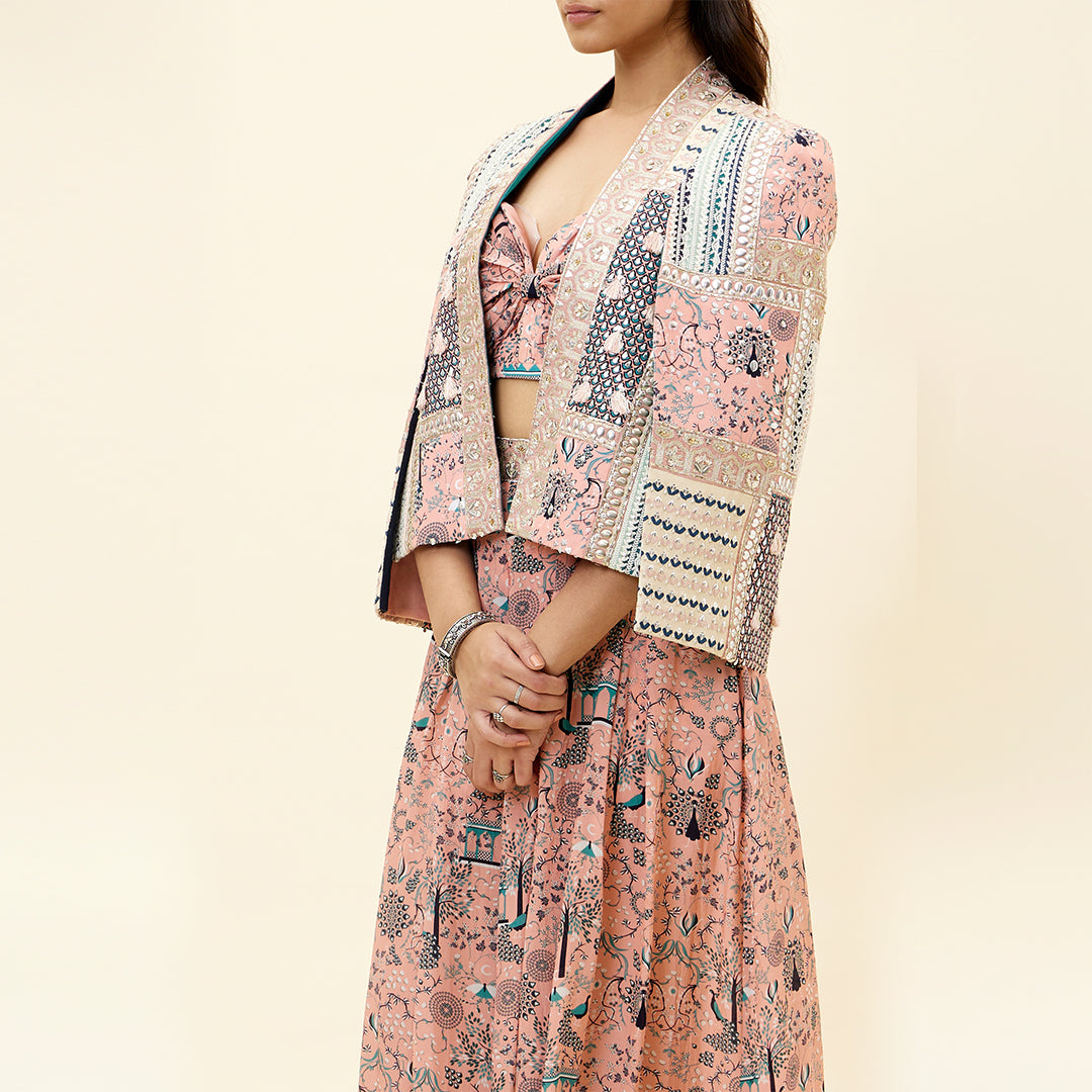PINK MOR JAAL PRINT BIKINI BUSTIER TEAMED WITH BOX PLEATED PANTS AND A PATCHWORK NOOR CAPE JACKET