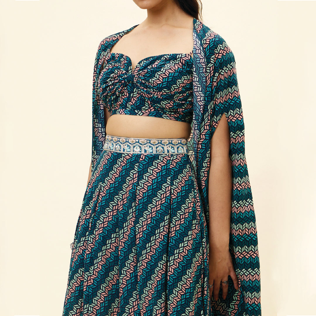 BLUE LEAF PRINT BIKINI BUSTIER TEAMED WITH BOX PLEAT PANTS AND A CAPE
