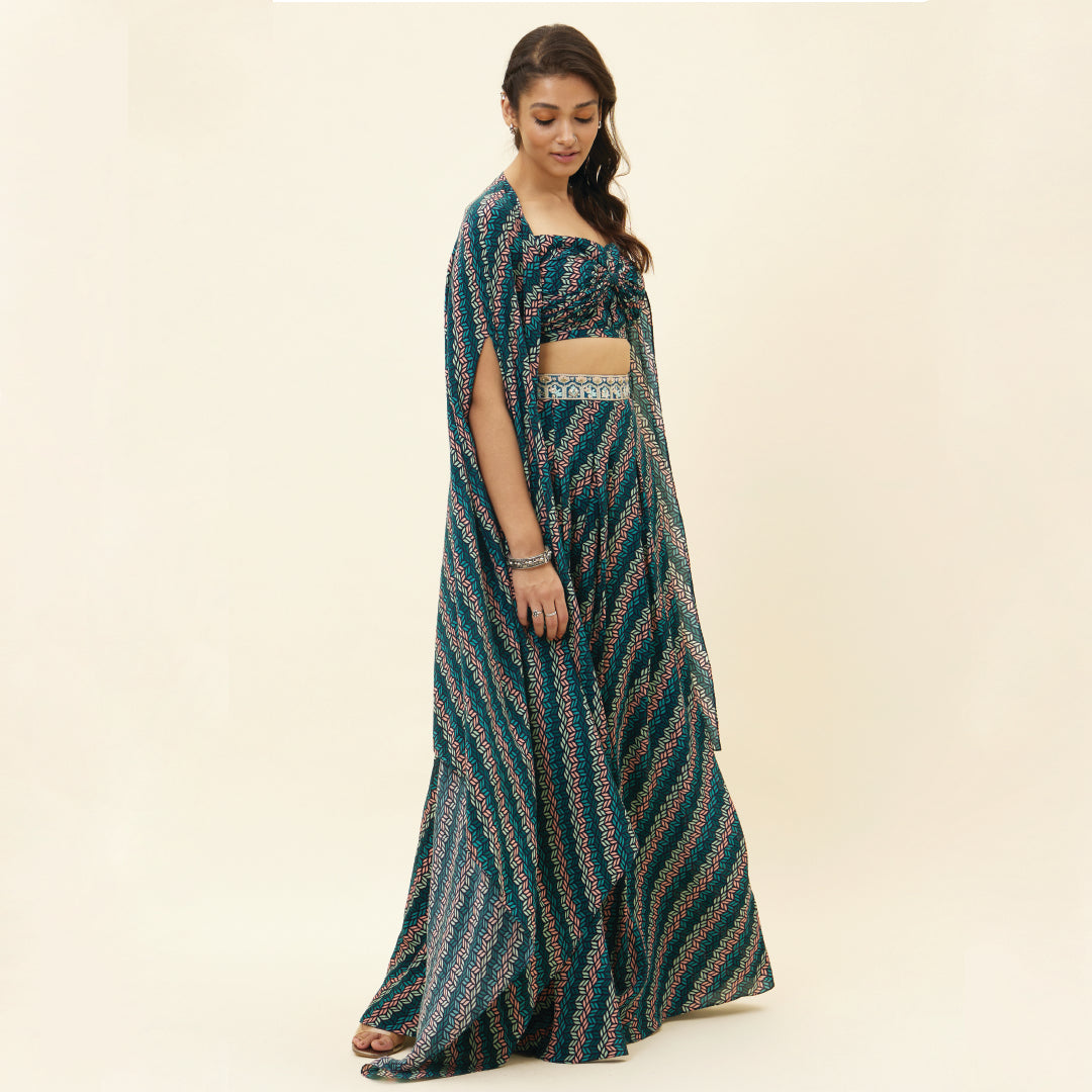 BLUE LEAF PRINT BIKINI BUSTIER TEAMED WITH BOX PLEAT PANTS AND A CAPE