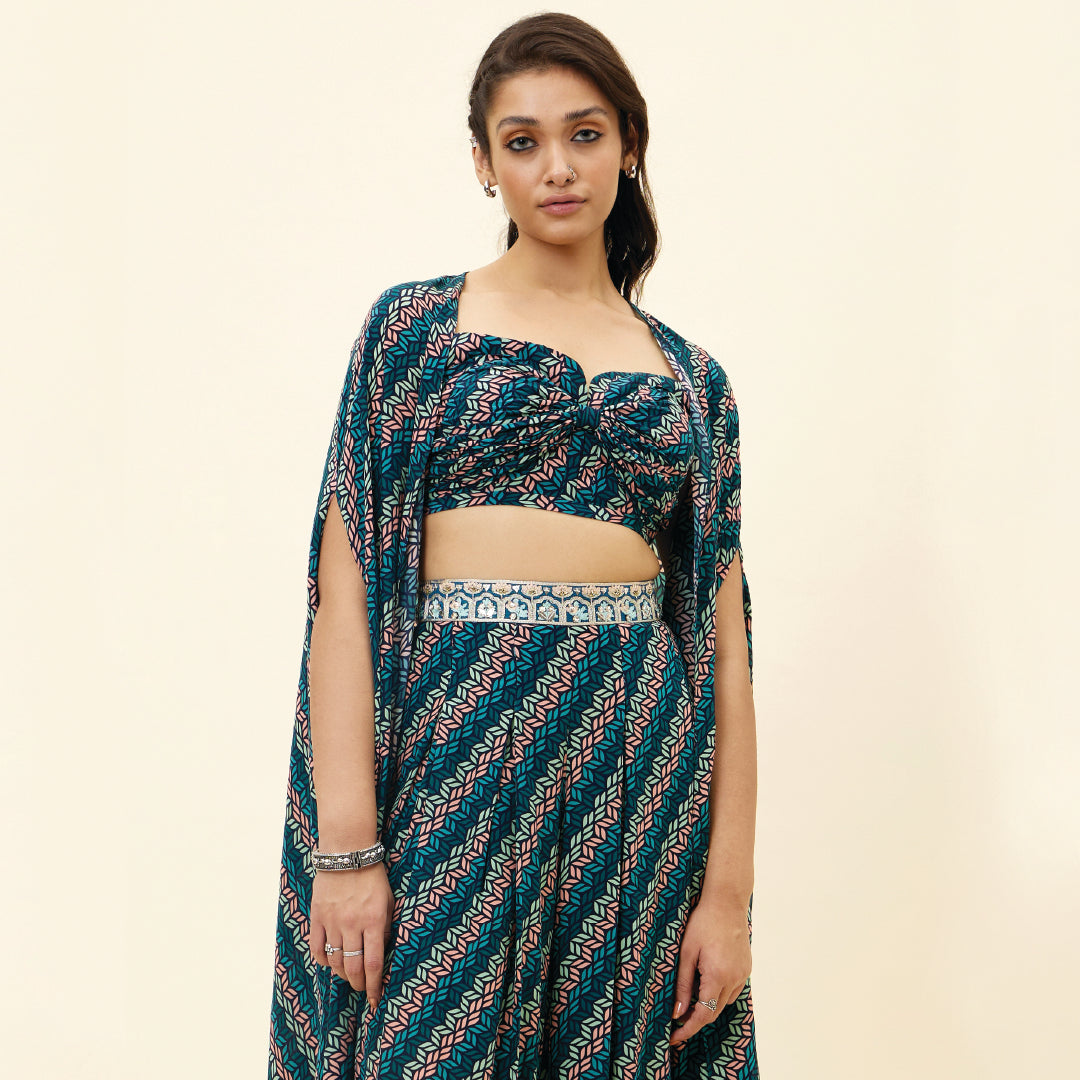 BLUE LEAF PRINT BIKINI BUSTIER TEAMED WITH BOX PLEAT PANTS AND A CAPE