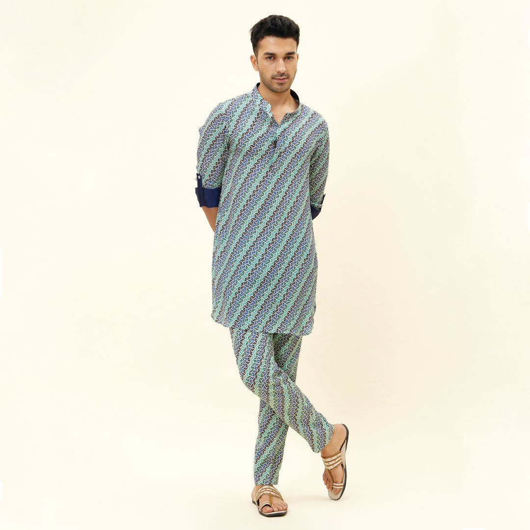 BEIGE LEAF PRINT SHORT SHIRT STYLE KURTA WITH ROLLED UP SLEEVES WITH BEIGE LEAF PRINT PANTS
