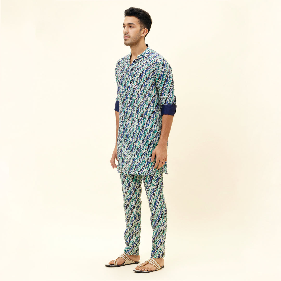 BEIGE LEAF PRINT SHORT SHIRT STYLE KURTA WITH ROLLED UP SLEEVES WITH BEIGE LEAF PRINT PANTS