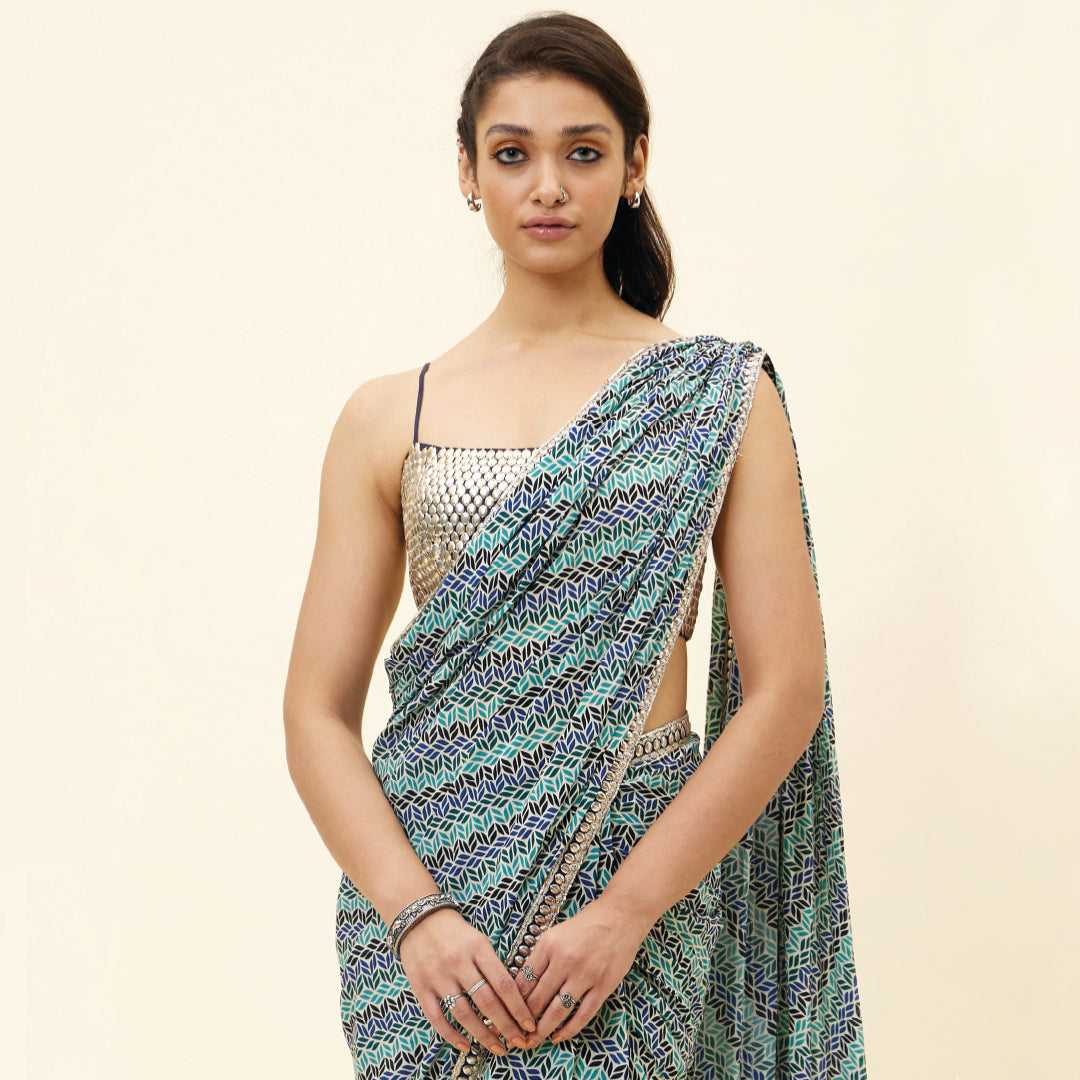 BEIGE LEAF PRINT PRE STITCHED CASCASE SAREE TEAMED WITH AN EMBELLISHED BLOUSE