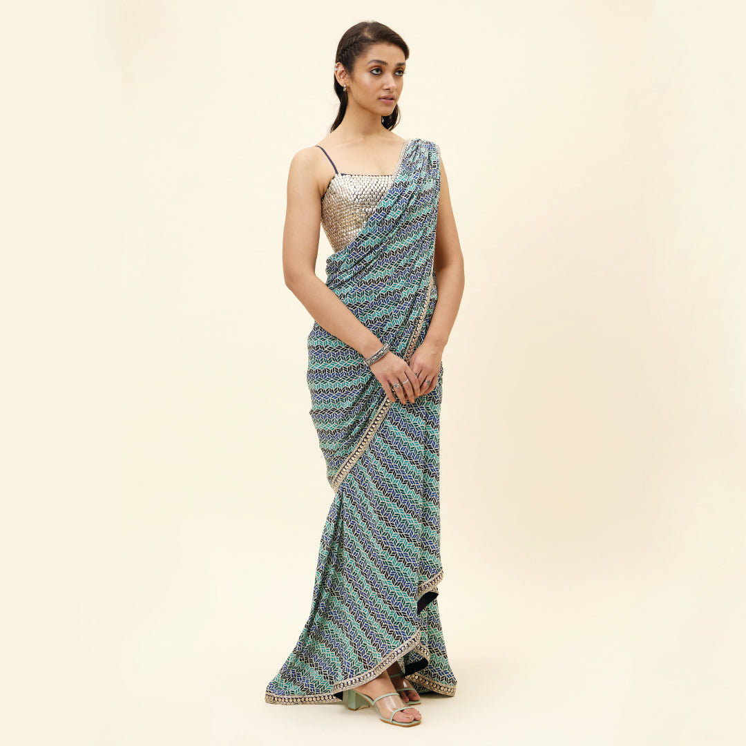 BEIGE LEAF PRINT PRE STITCHED CASCASE SAREE TEAMED WITH AN EMBELLISHED BLOUSE