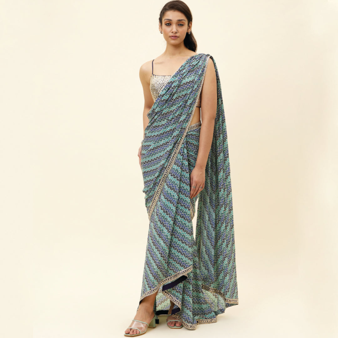 BEIGE LEAF PRINT PRE STITCHED CASCASE SAREE TEAMED WITH AN EMBELLISHED BLOUSE