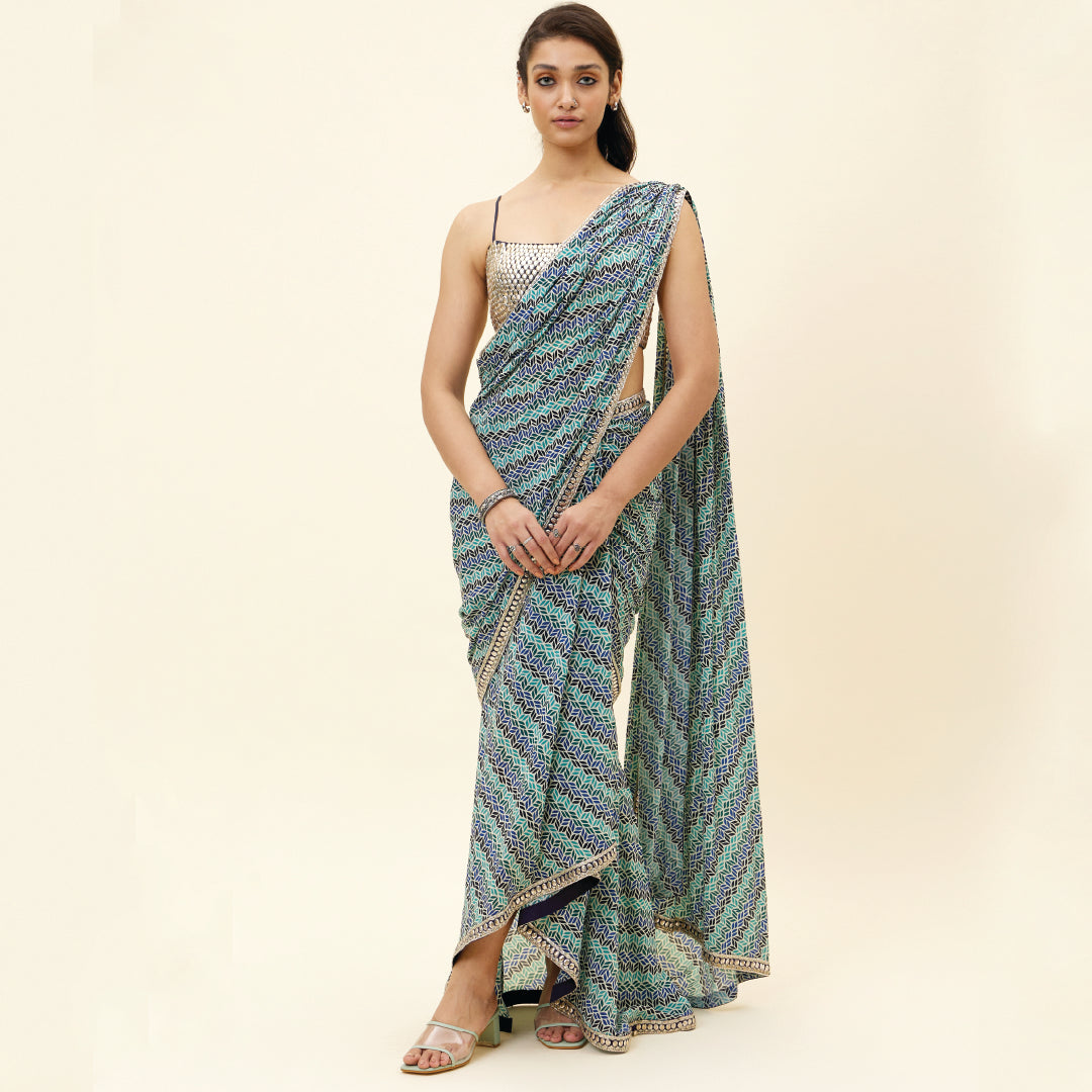 BEIGE LEAF PRINT PRE STITCHED CASCASE SAREE TEAMED WITH AN EMBELLISHED BLOUSE