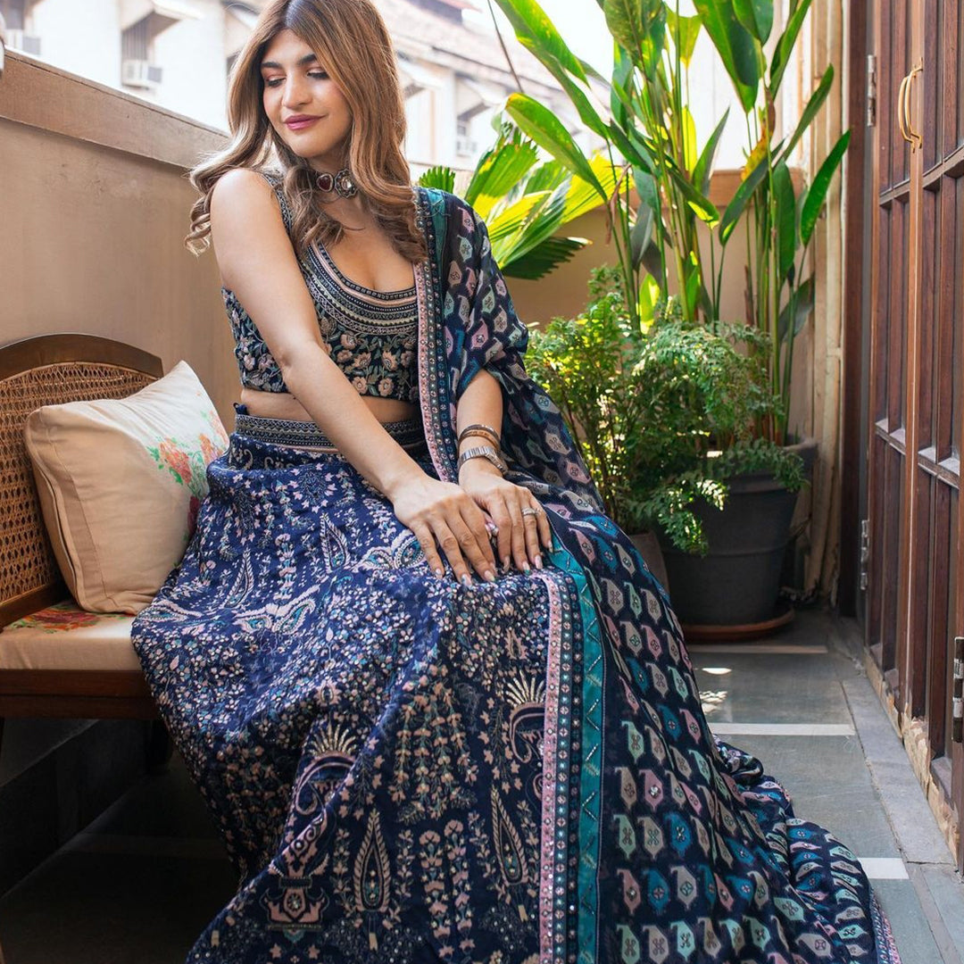 Floral Embellished blouse paired with printed lehenga with sublte embellishments and kairi printed organza dupatta and belt