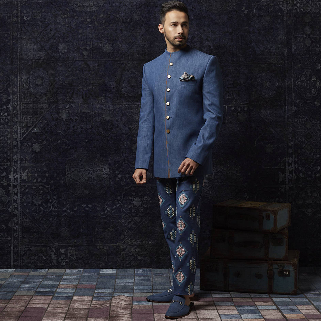 Medium blue Denim bandhgala with sued detailing paired with printed denim pants