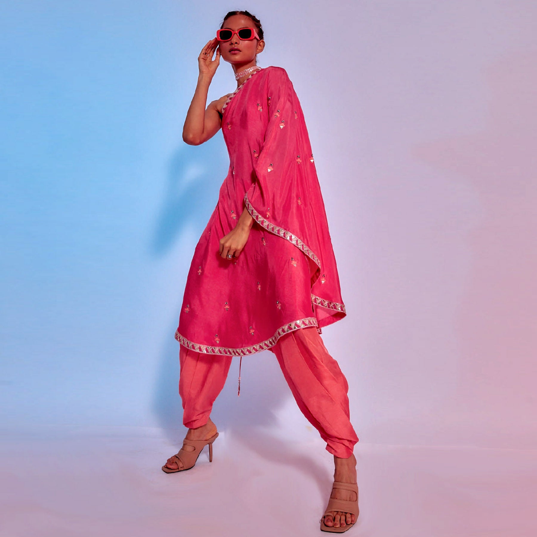 EMBELLISHED CORAL ONE SHOULDER DRAPED KURTA TEAMED WITH CORAL DRAPED PANTS