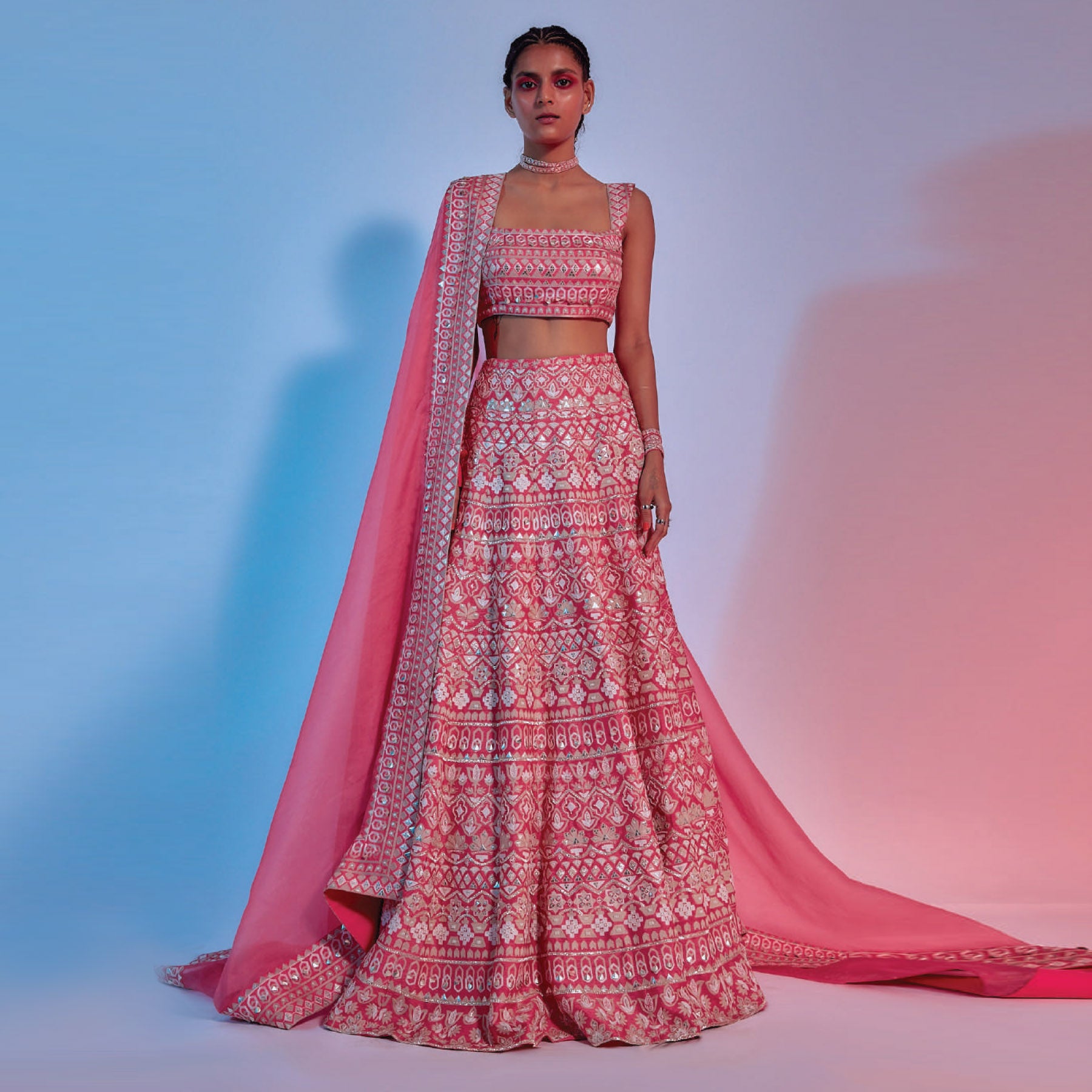 INTRICATE EMBELLISHED CORAL LEHENGA TEAMED WITH EMBELLISHED CORAL BUSTIER AND CORAL ORGANZA DUPATTA