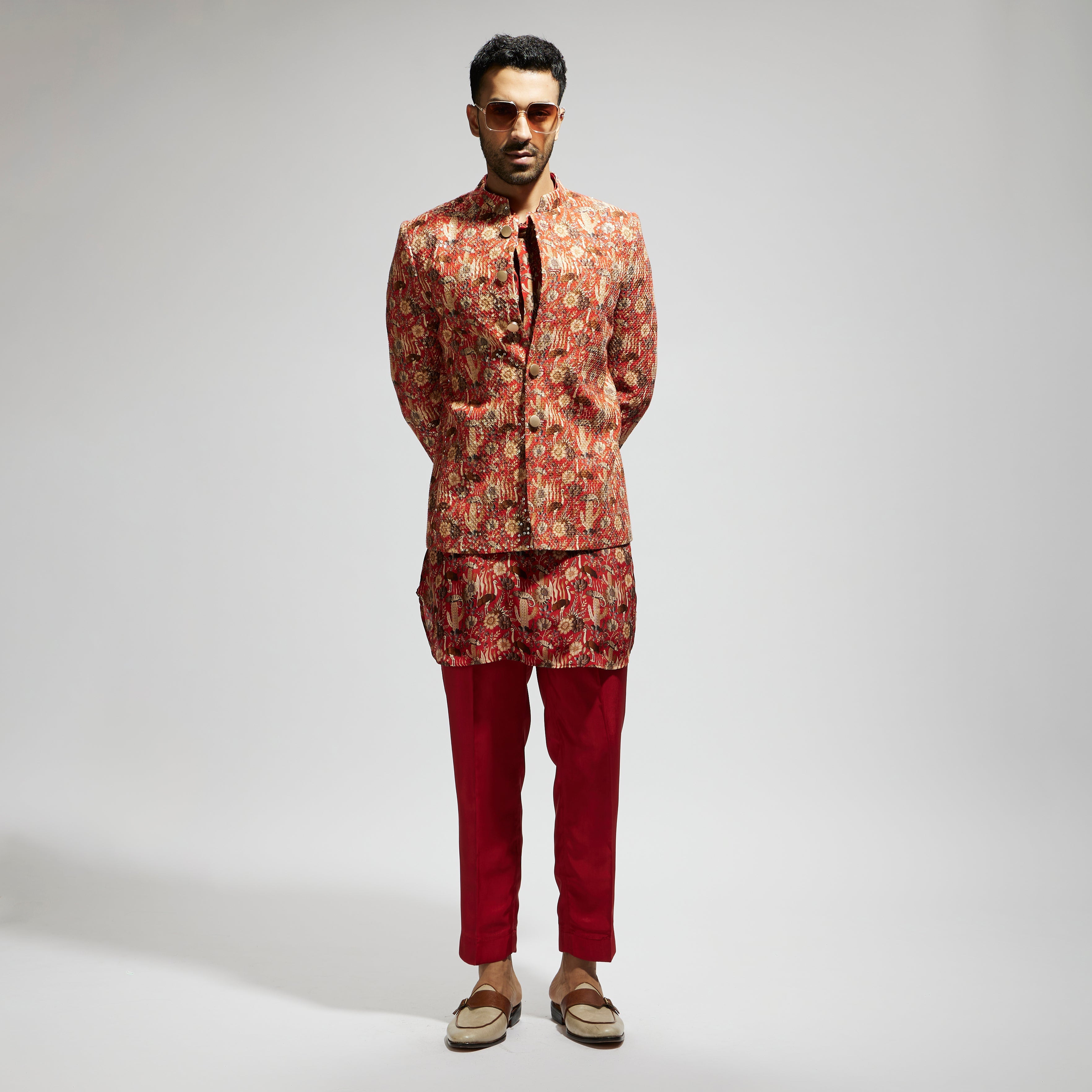 SAMSARA: ORANGE JAAL EMBELLISHED BANDHGALA PAIRED WITH JAAL KURTA AND PANTS