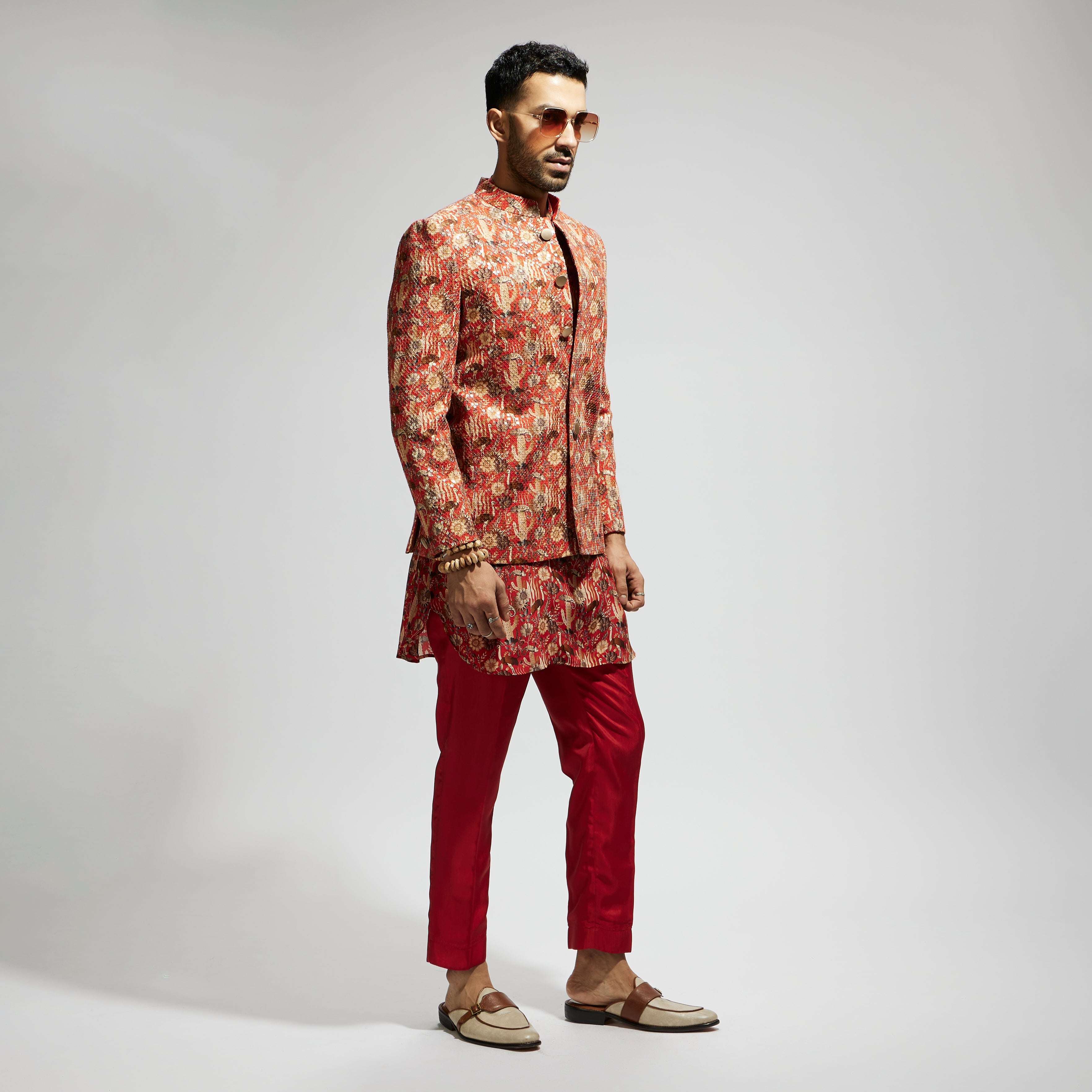 SAMSARA: ORANGE JAAL EMBELLISHED BANDHGALA PAIRED WITH JAAL KURTA AND PANTS