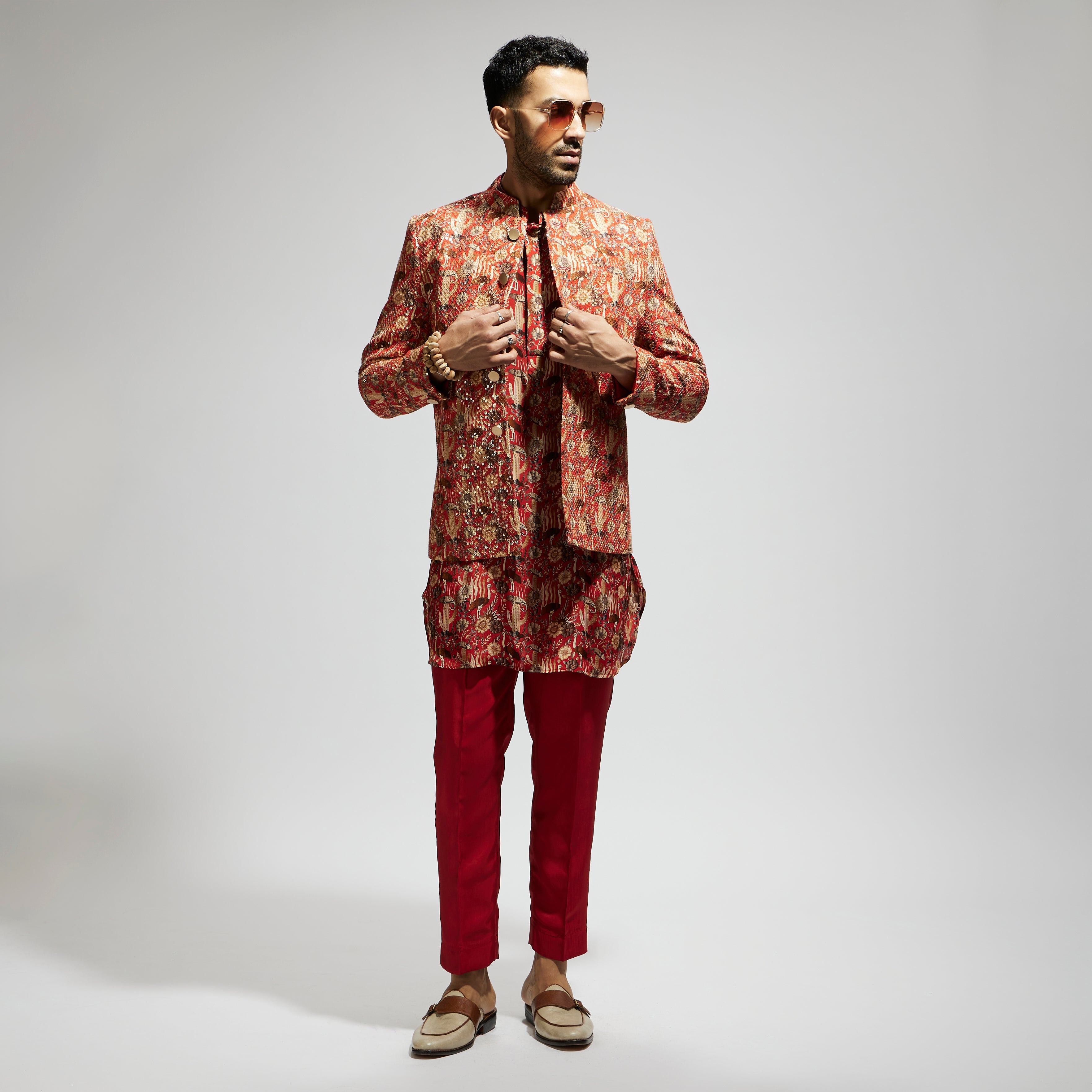 SAMSARA: ORANGE JAAL EMBELLISHED BANDHGALA PAIRED WITH JAAL KURTA AND PANTS