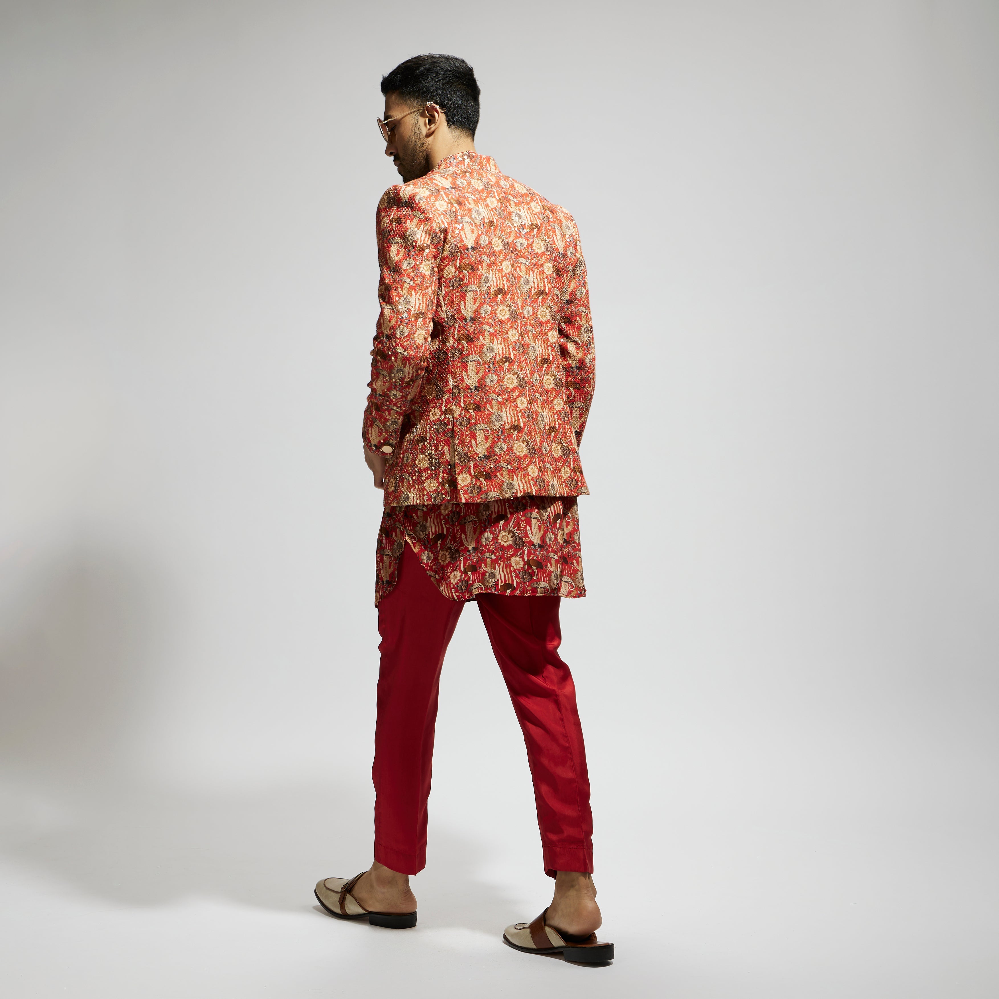 SAMSARA: ORANGE JAAL EMBELLISHED BANDHGALA PAIRED WITH JAAL KURTA AND PANTS