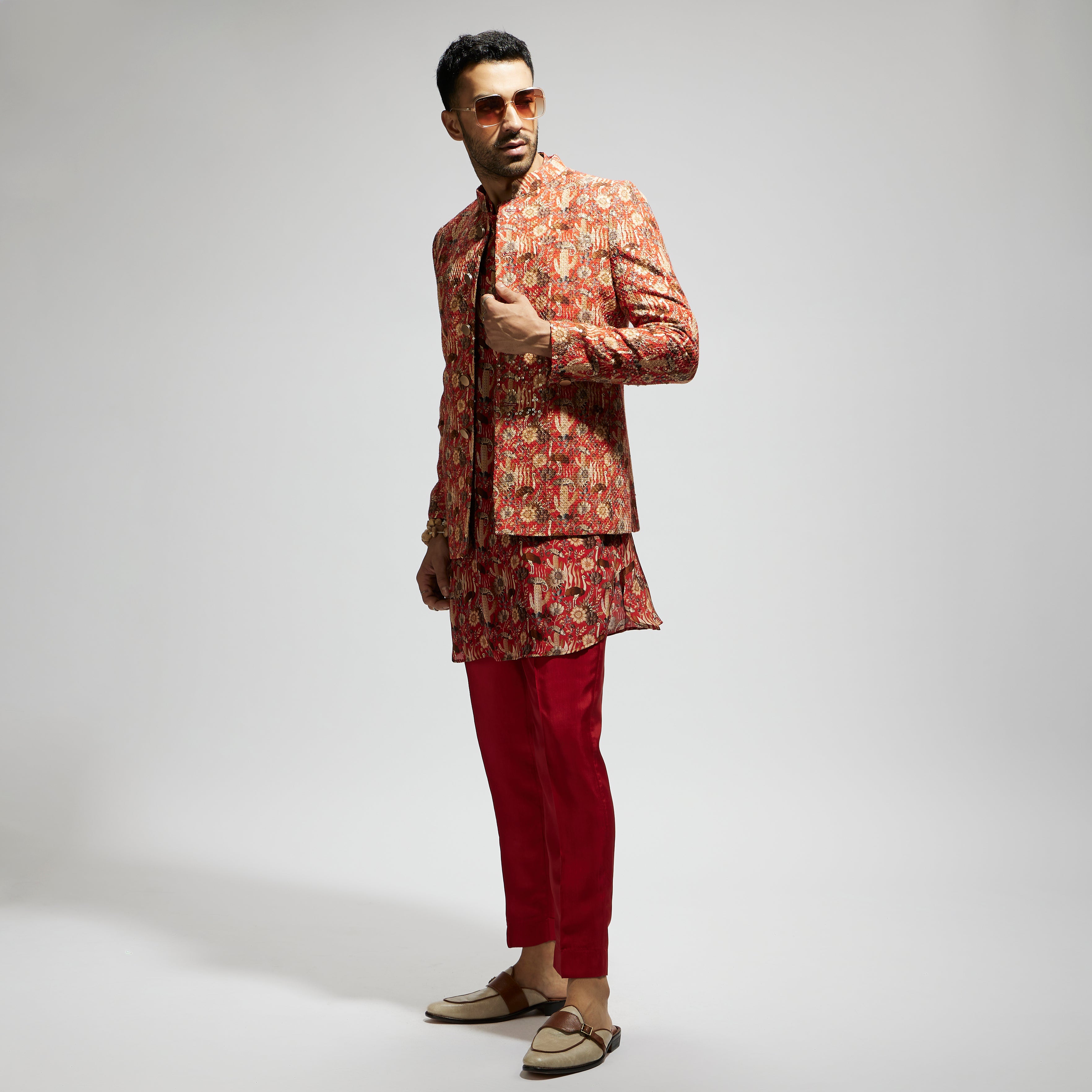 SAMSARA: ORANGE JAAL EMBELLISHED BANDHGALA PAIRED WITH JAAL KURTA AND PANTS