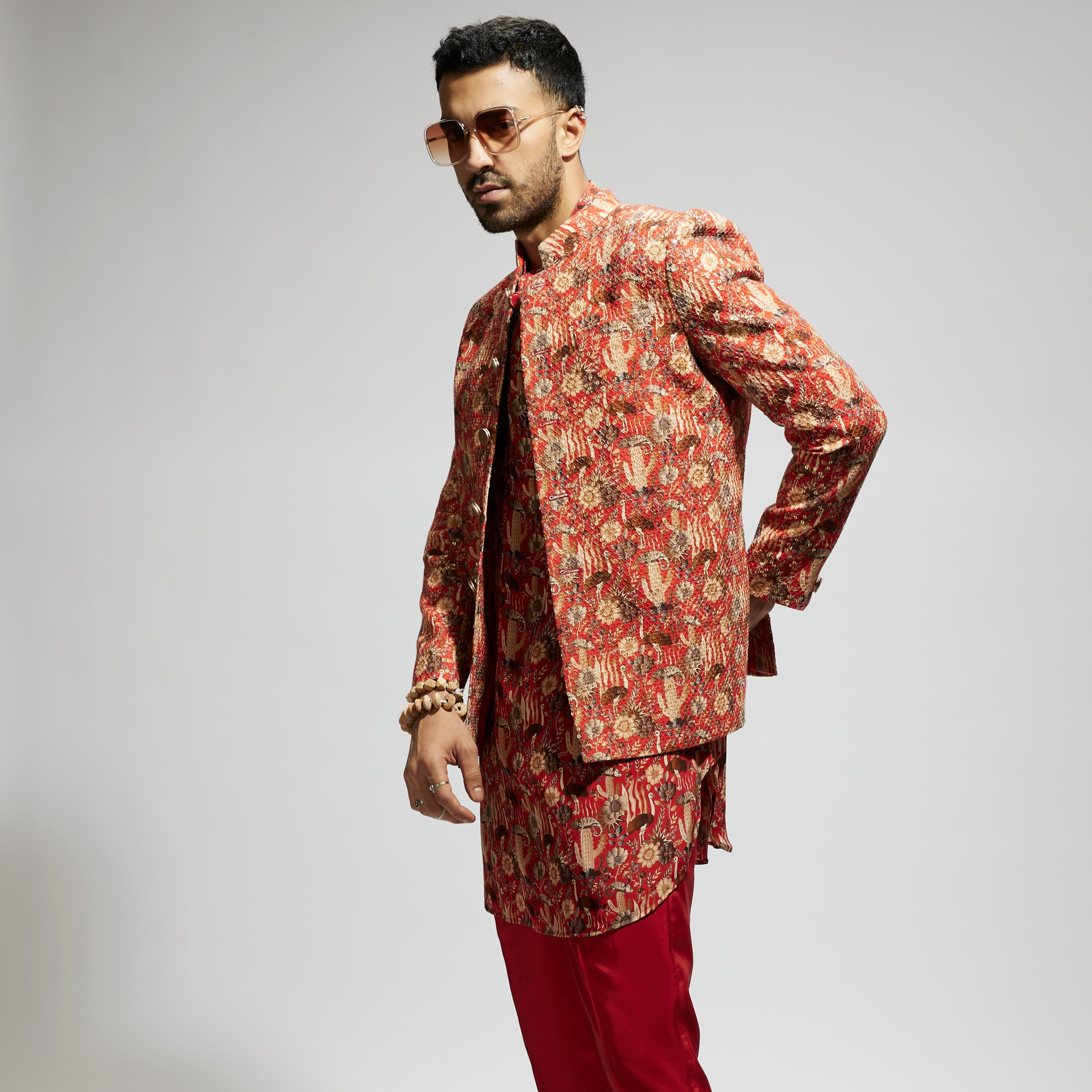 SAMSARA: ORANGE JAAL EMBELLISHED BANDHGALA PAIRED WITH JAAL KURTA AND PANTS