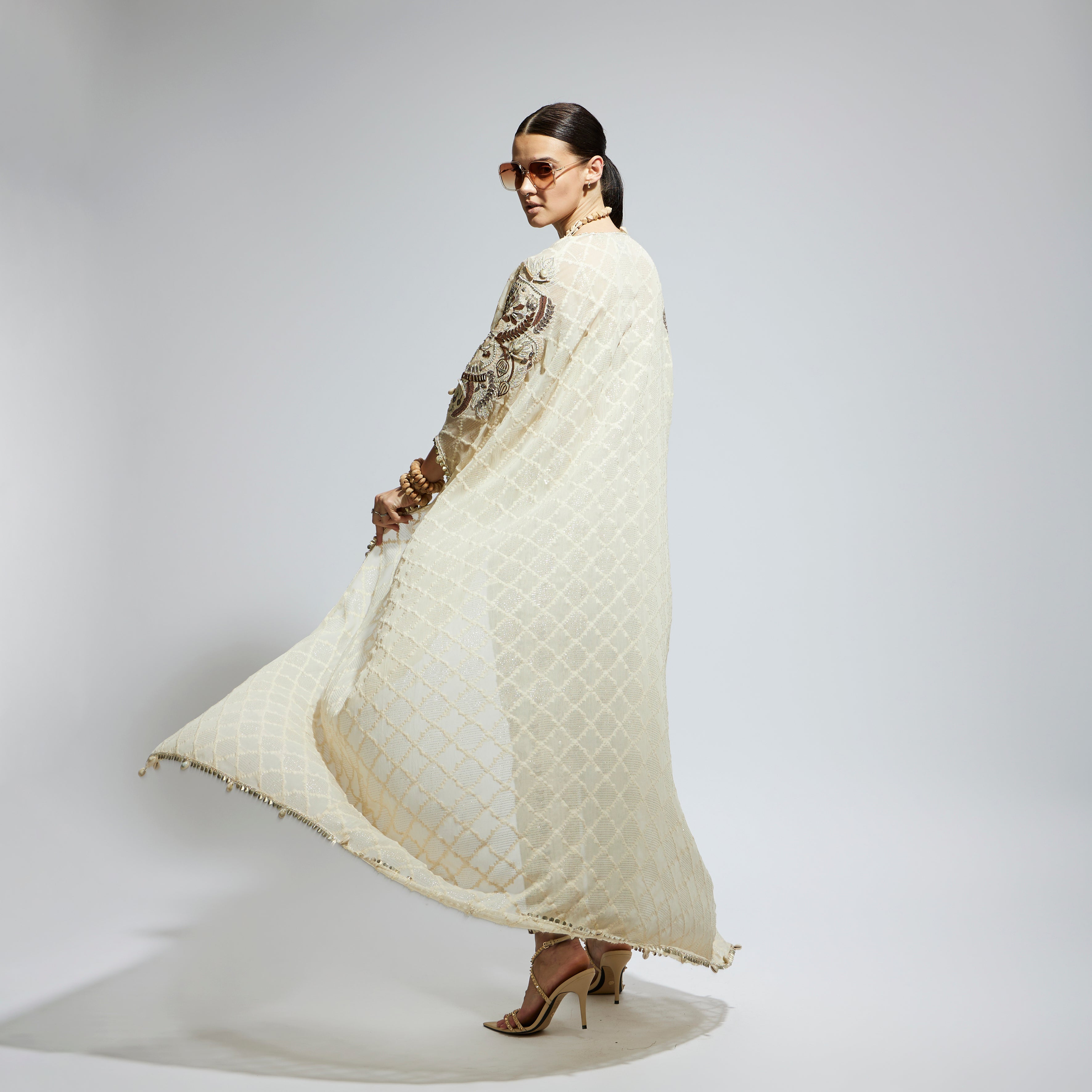 SAMSARA: IVORY AZTEC EMBELLISHED CAPE PAIRED WITH HEAVILY EMBELLISHED BUSTIER AND PANTS