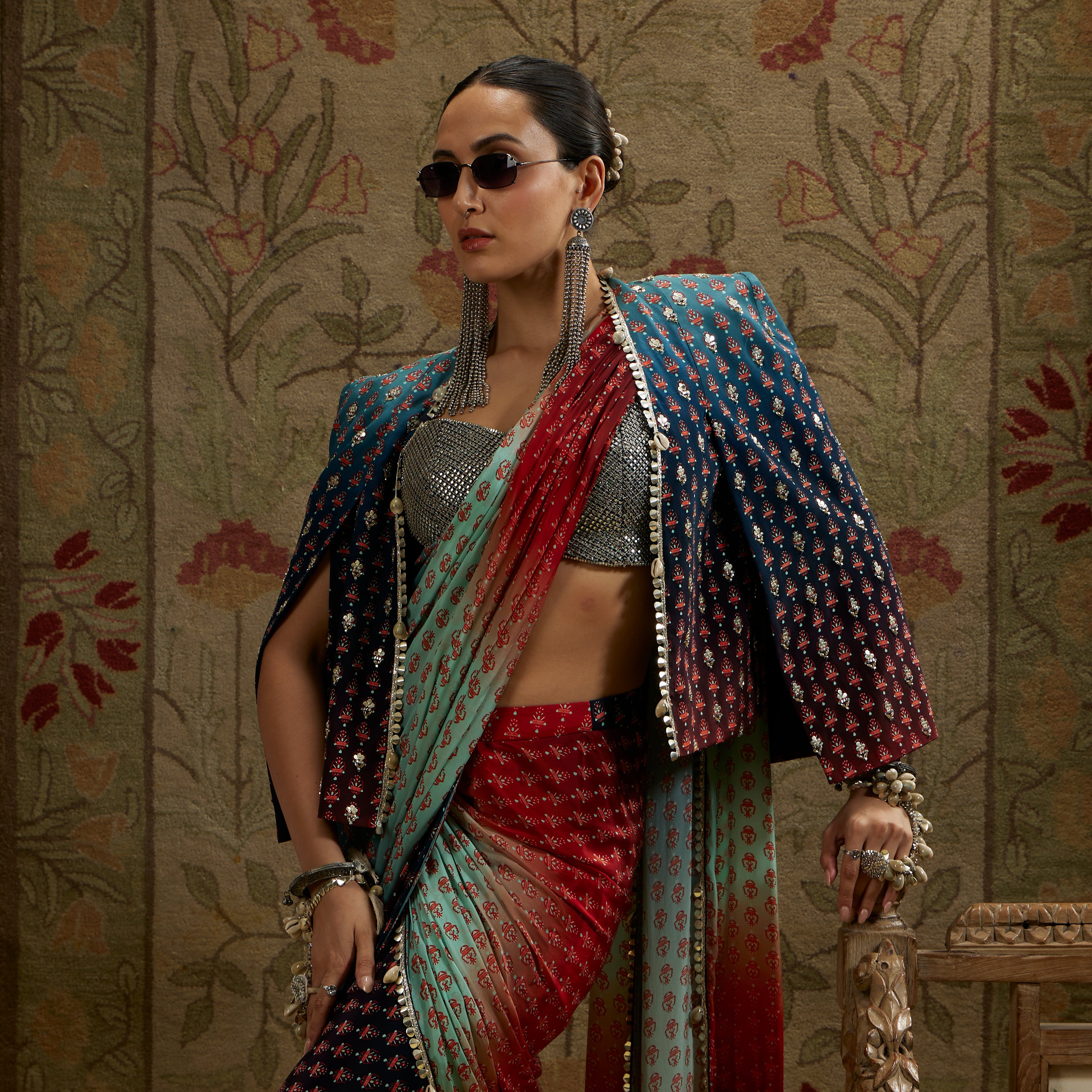 RED & BLUE OMBRE PRINT CASCADE SAREE WITH METAL EMBELLISHED BUSTIER PAIRED WITH BLUE OMBRE EMBELLISHED CAPE JACKET