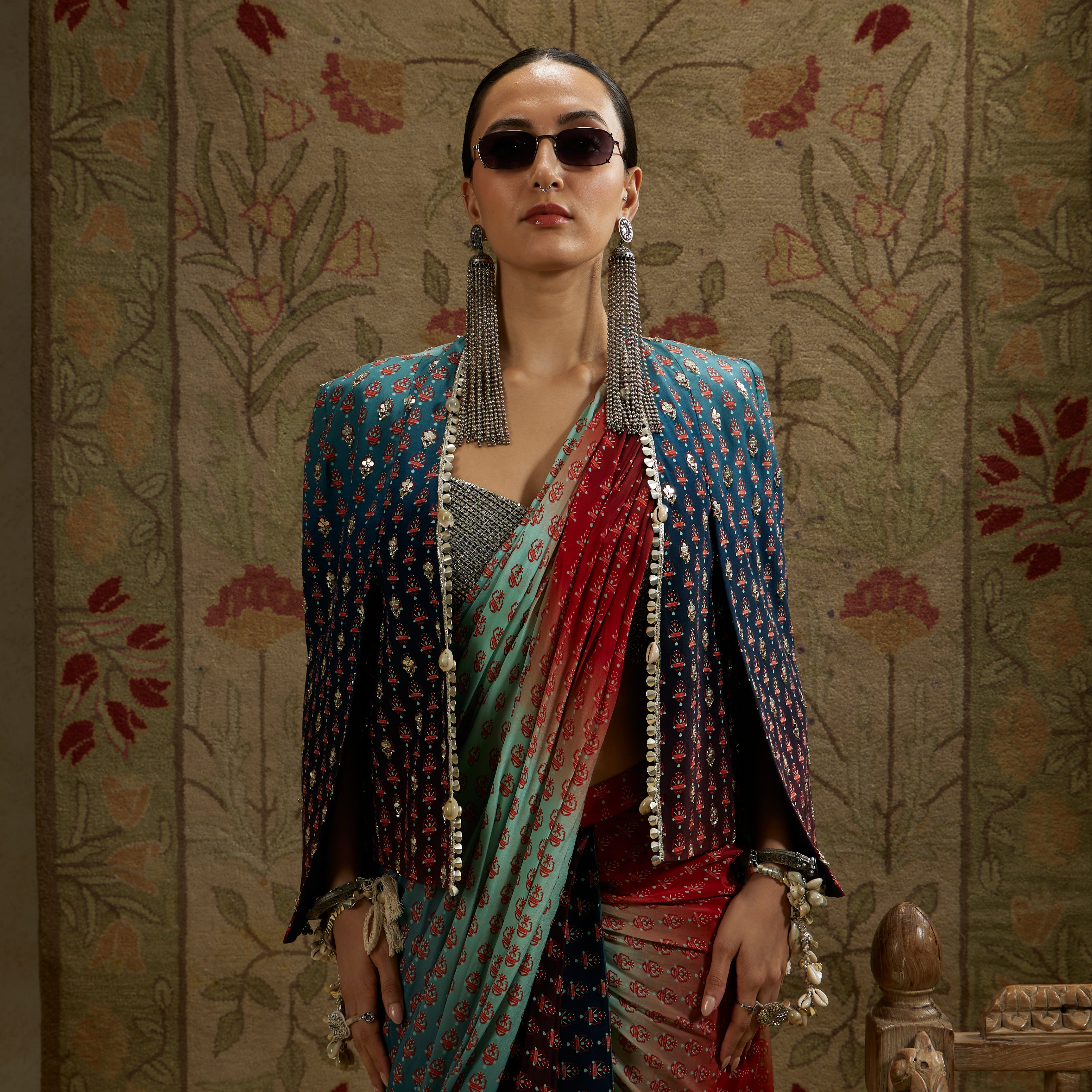 RED & BLUE OMBRE PRINT CASCADE SAREE WITH METAL EMBELLISHED BUSTIER PAIRED WITH BLUE OMBRE EMBELLISHED CAPE JACKET