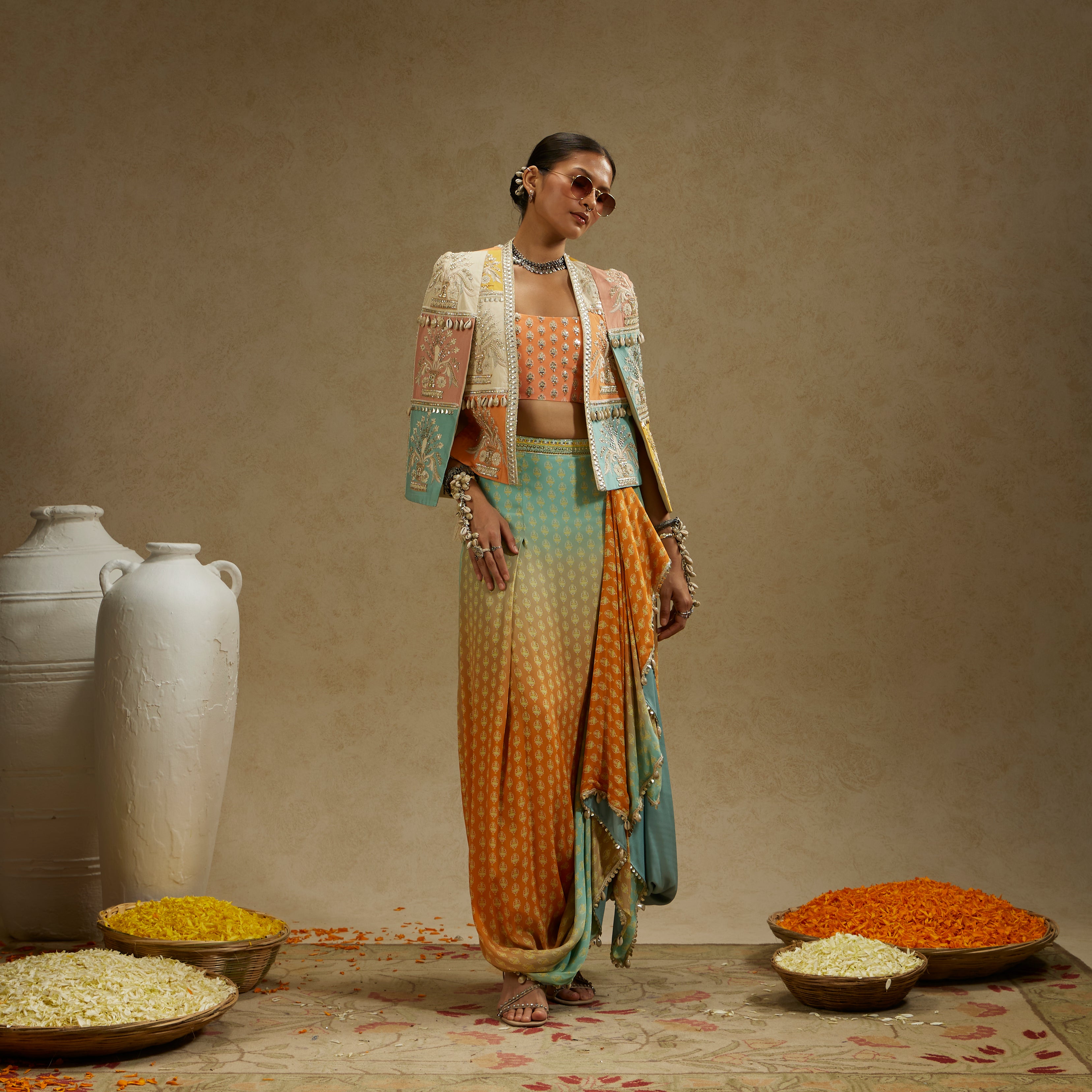 COLOUR BLOCKED PATCHWORK CAPE JACKET PAIRED WITH AN EMBELLISHED BUSTIER AND AN OMBRE PRINTED DRAPED SKIRT