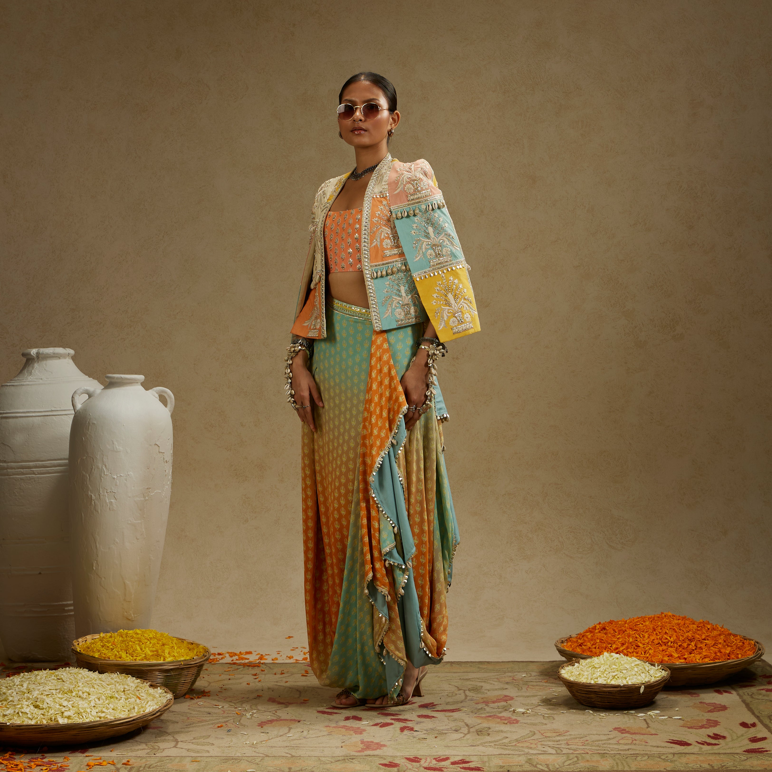 COLOUR BLOCKED PATCHWORK CAPE JACKET PAIRED WITH AN EMBELLISHED BUSTIER AND AN OMBRE PRINTED DRAPED SKIRT