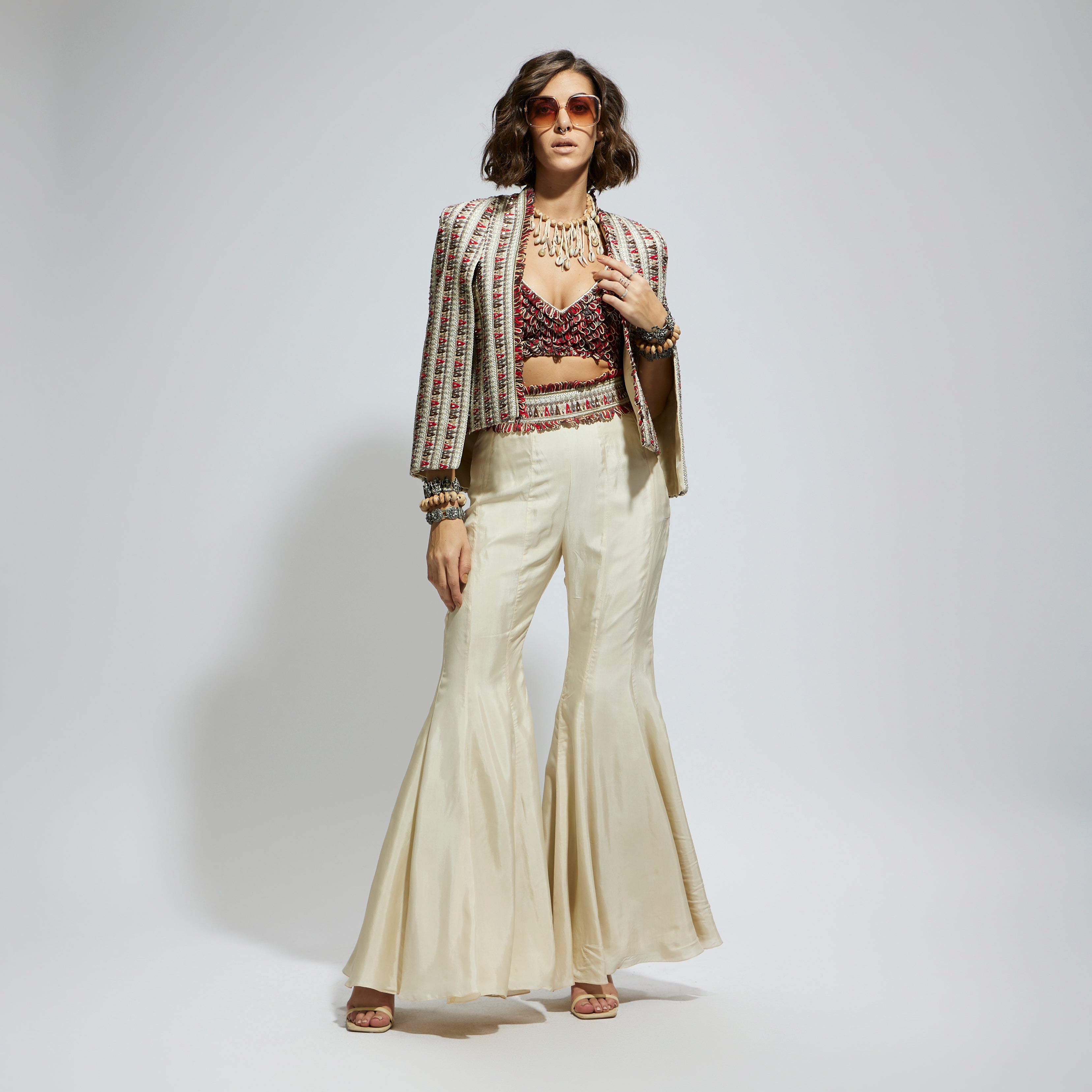 SAMSARA: IVORY EMBELLISHED CAPE JACKET PAIRED WITH TEXTURED BUSTIER AND SHARARA PANTS