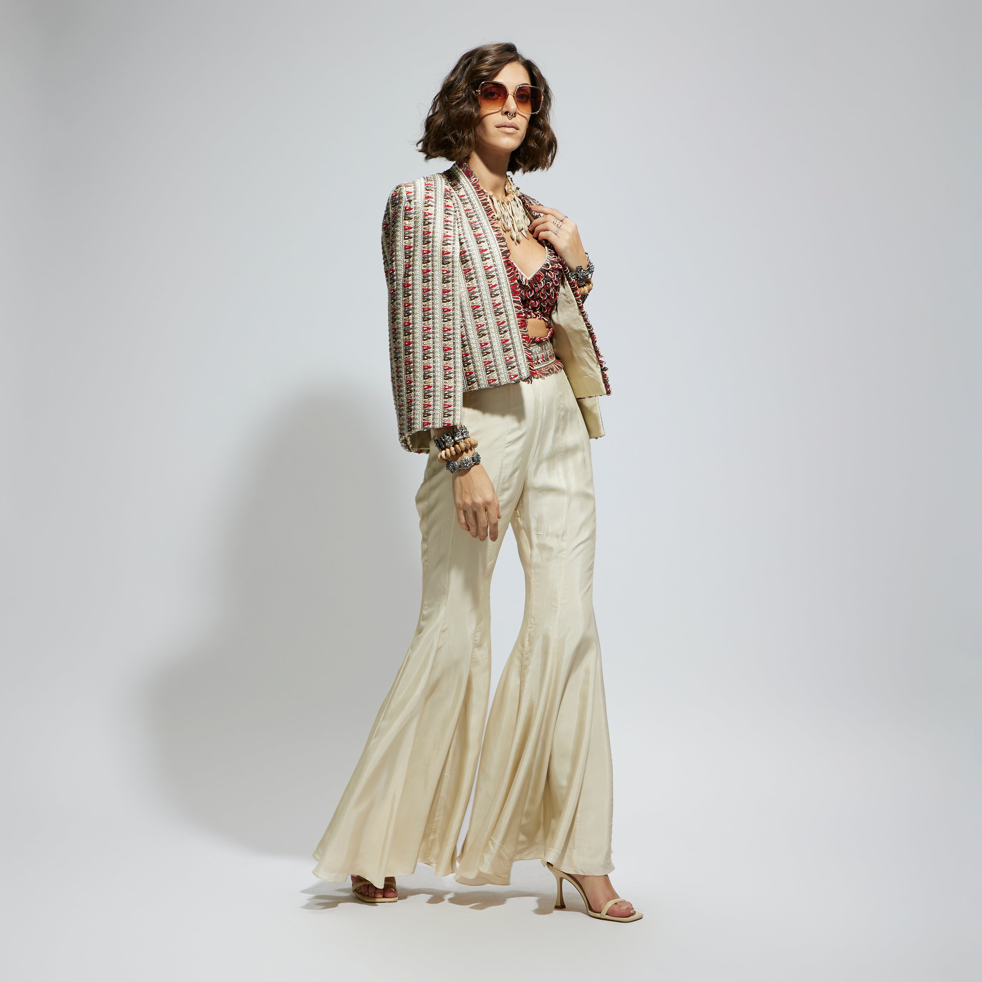 IVORY EMBELLISHED CAPE JACKET PAIRED WITH TEXTURED BUSTIER AND SHARARA PANTS