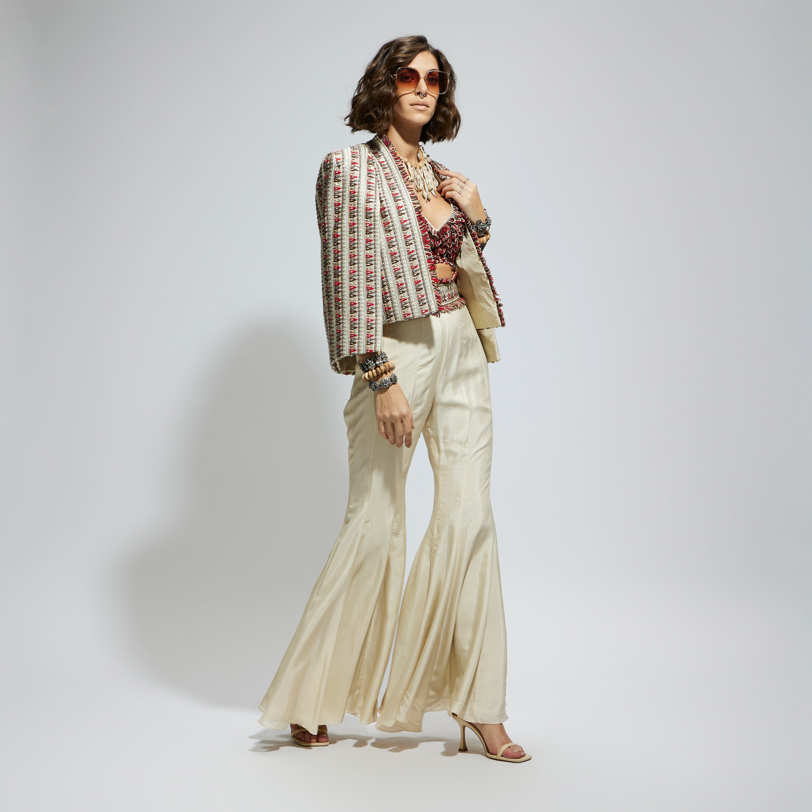 SAMSARA: IVORY EMBELLISHED CAPE JACKET PAIRED WITH TEXTURED BUSTIER AND SHARARA PANTS