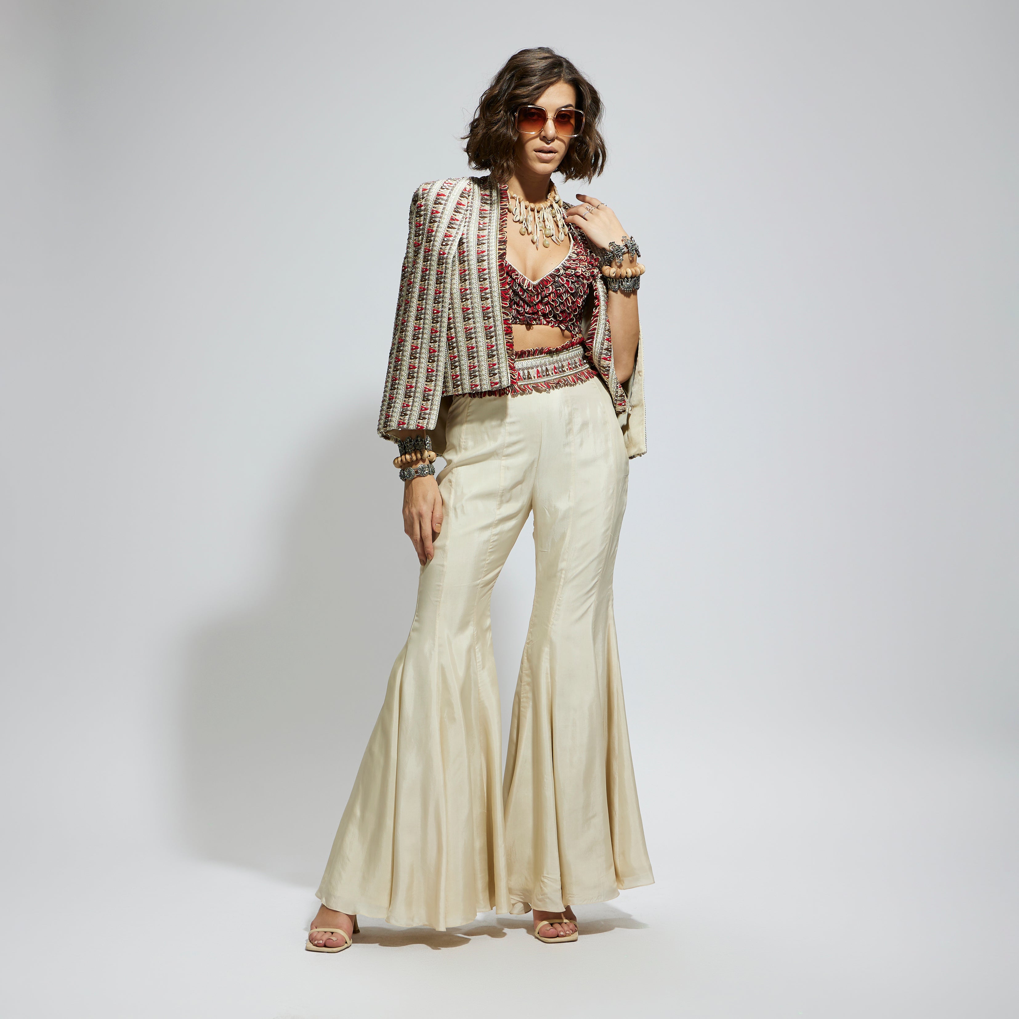 SAMSARA: IVORY EMBELLISHED CAPE JACKET PAIRED WITH TEXTURED BUSTIER AND SHARARA PANTS