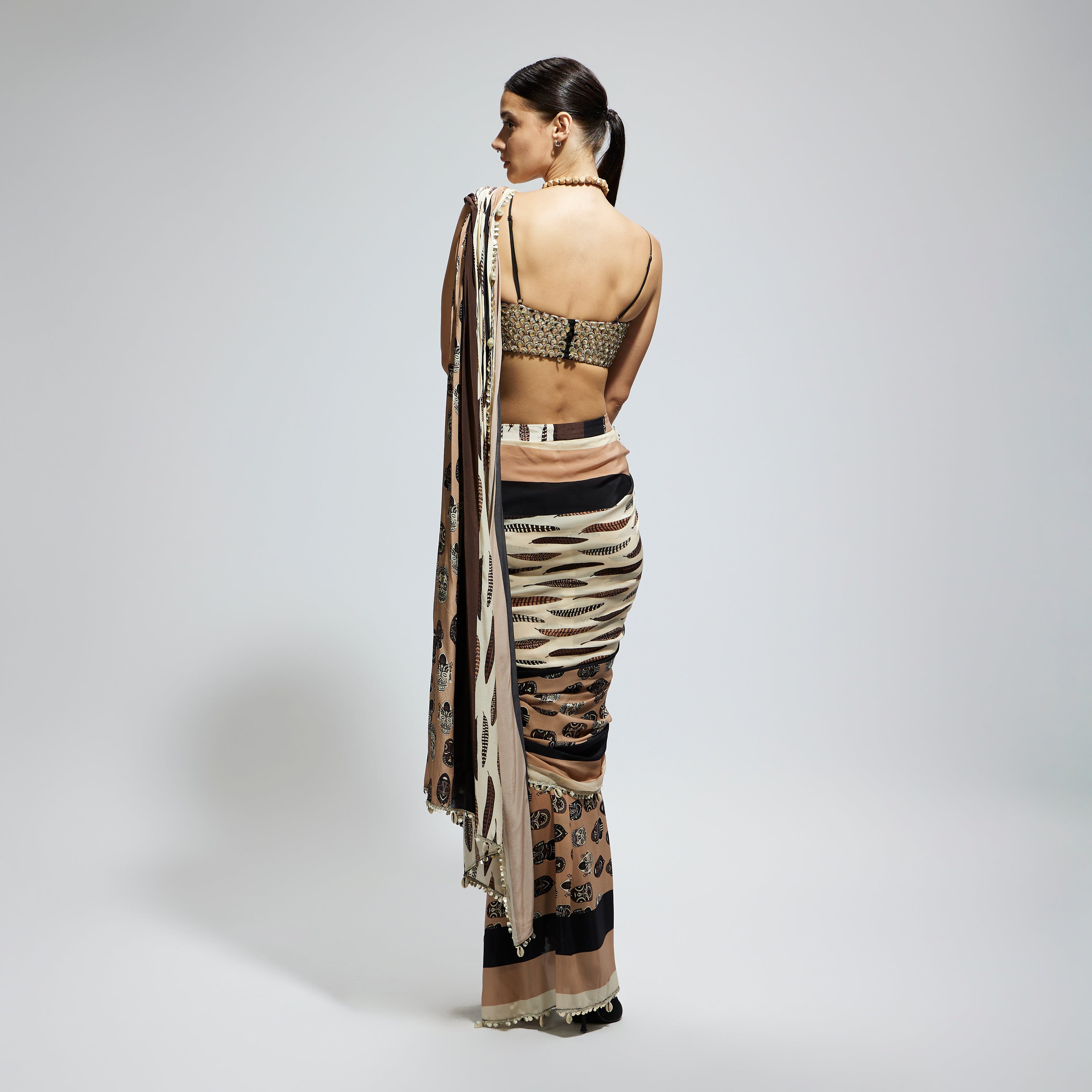 MASK AND FEATHER PRINT CASCADE SAREE PAIRED WITH METALLIC SCALLOP BUSTIER