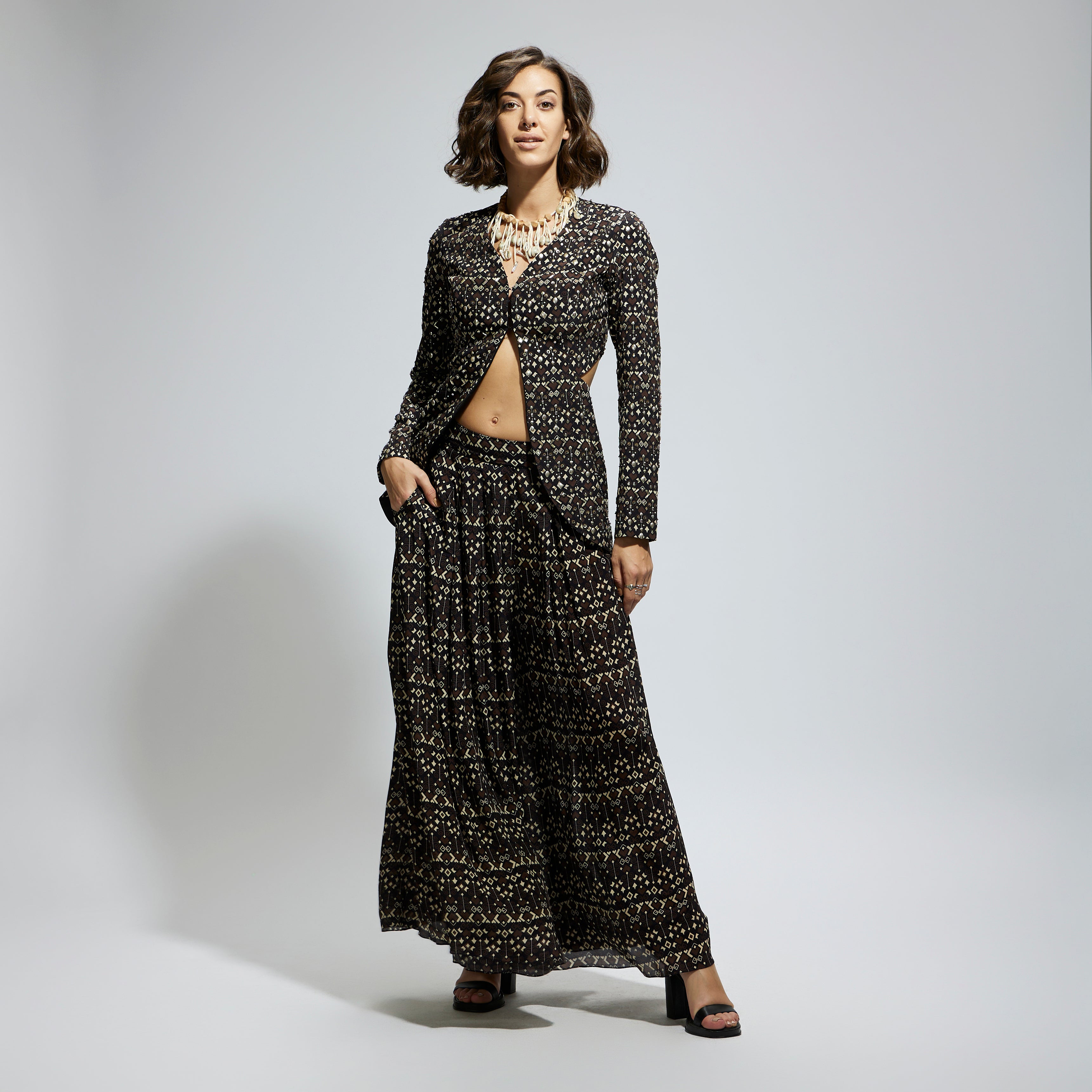 SAMSARA: BLACK EMBELLISHED SIDE CUT OUT JACKET WITH PRINTED FLARED PANTS