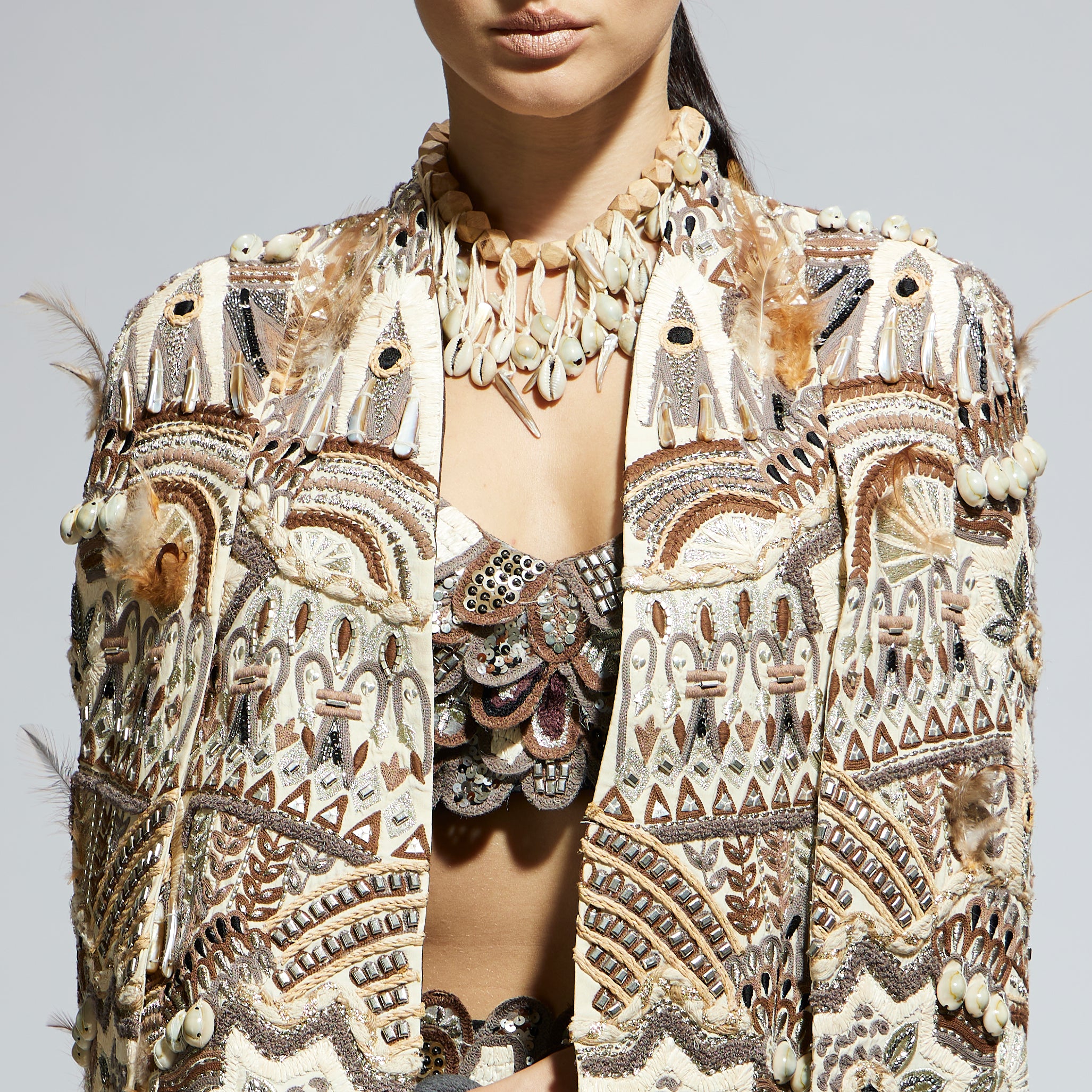 IVORY ABSTRACT FEATHER CAPE JACKET PAIRED WITH 3D SCALLOP BUSTIER AND BLACK HIGH SLIT SKIRT