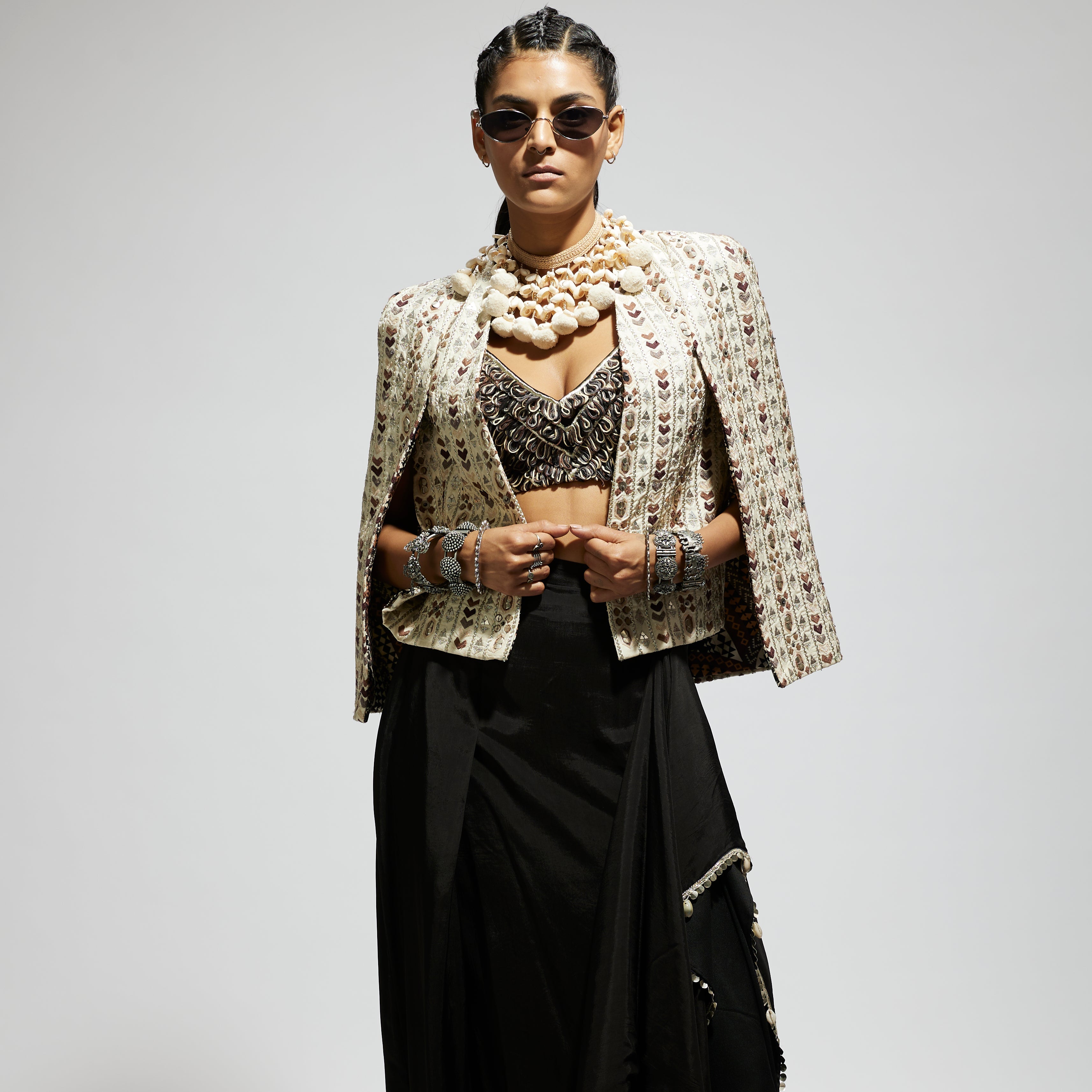 SAMSARA: IVORY EMBELLISHED CAPE JACKET PAIRED WITH TEXTURED BUSTIER AND DRAPE SKIRT