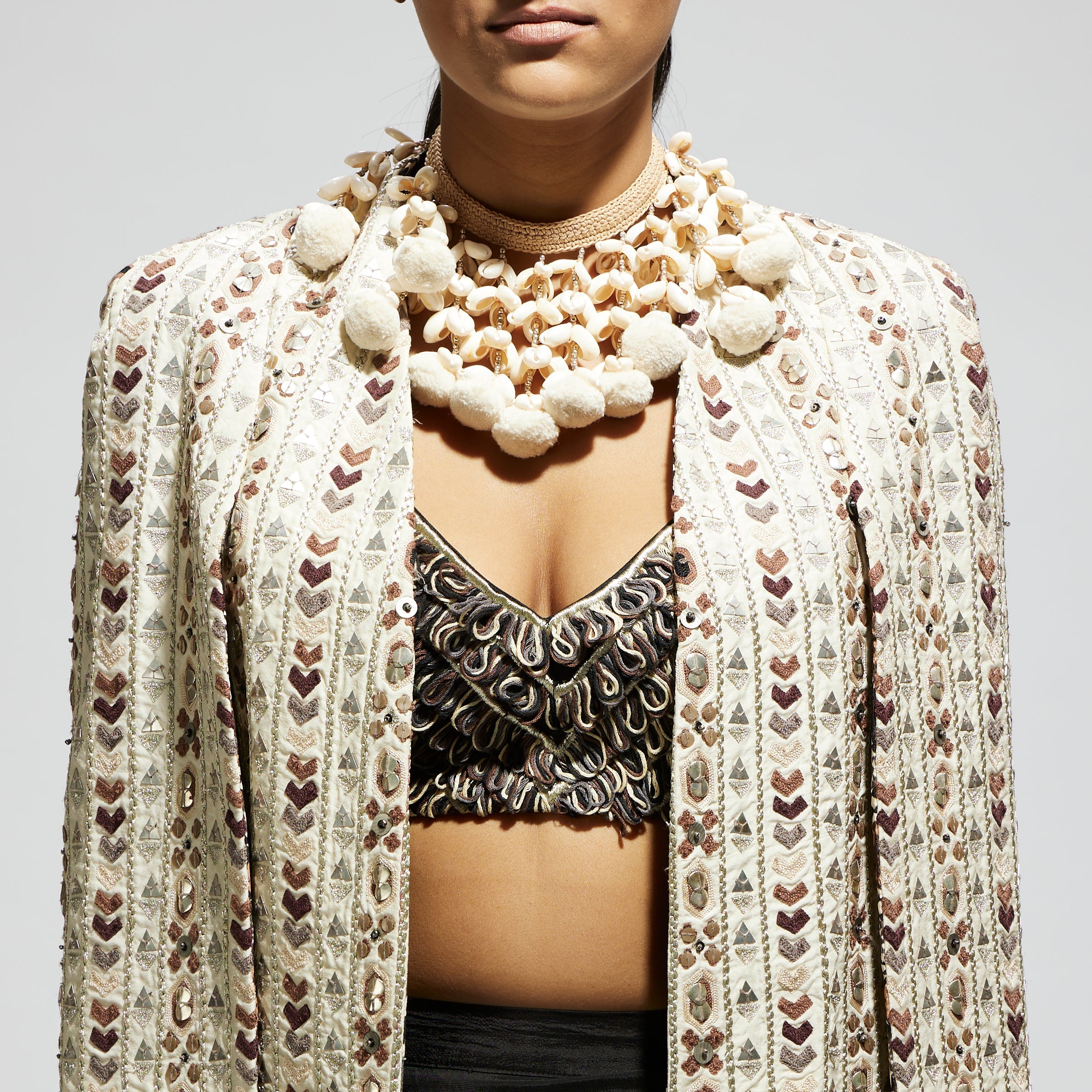 SAMSARA: IVORY EMBELLISHED CAPE JACKET PAIRED WITH TEXTURED BUSTIER AND DRAPE SKIRT