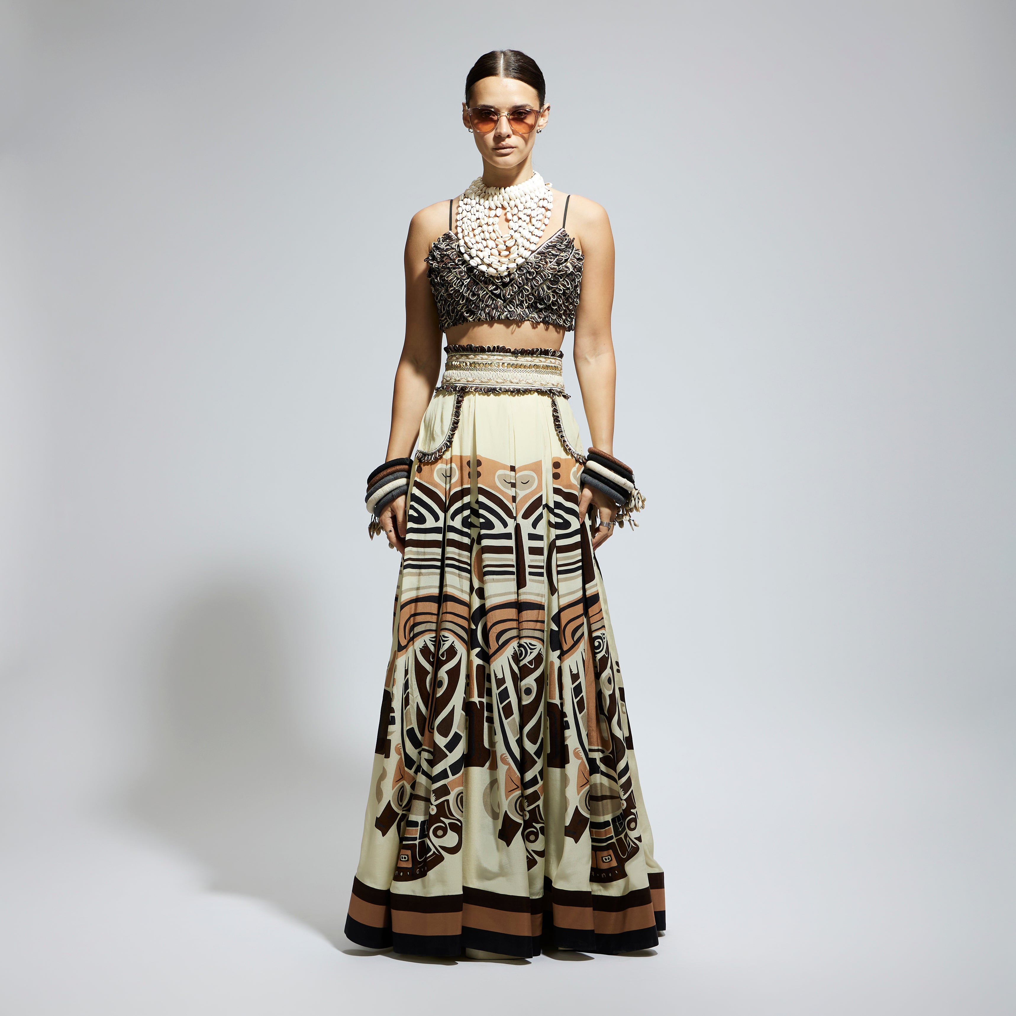 IVORY MASK PRINTED BOX PLEATED SKIRT WITH POCKETS TEAMED WITH A TEXTURED BUSTIER