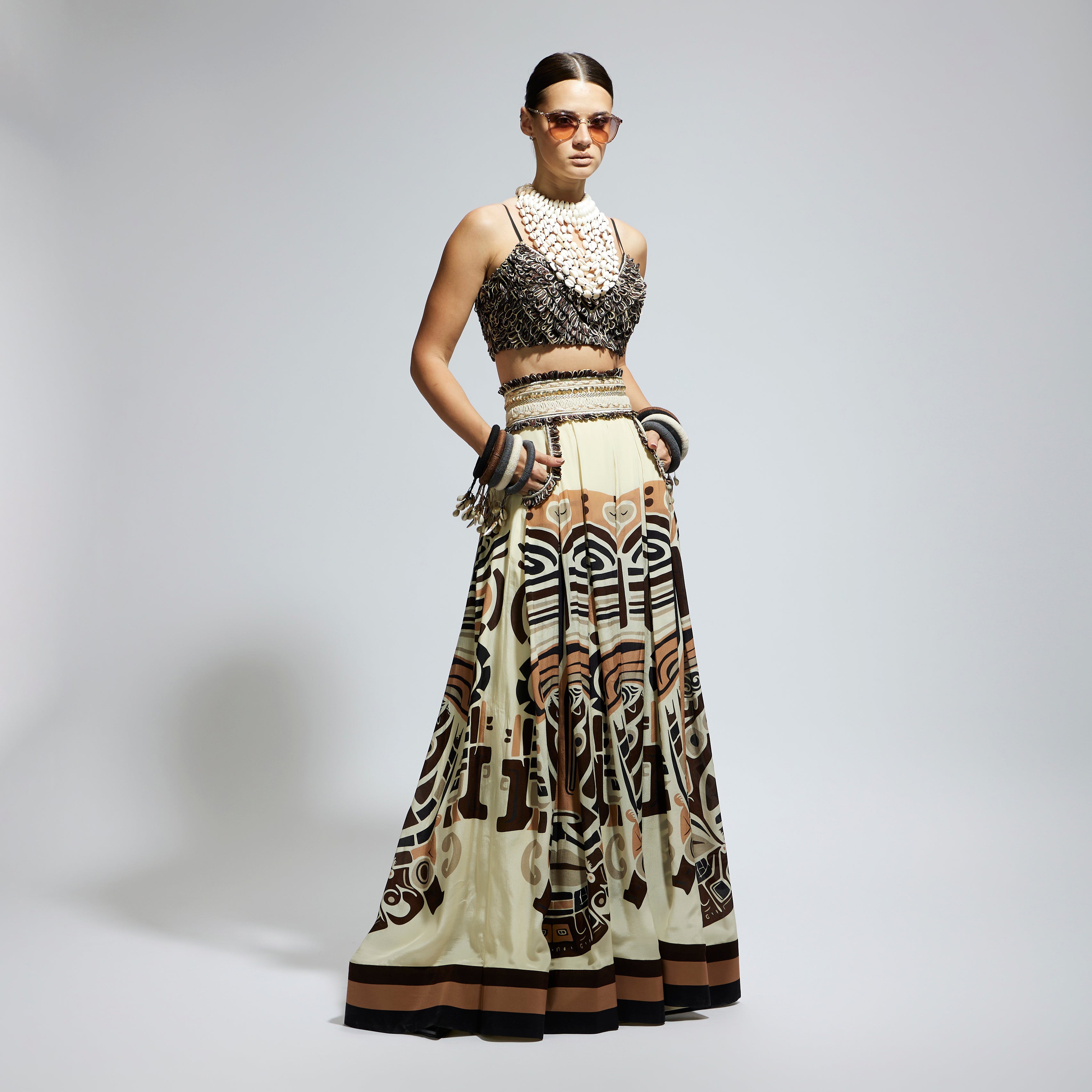 IVORY MASK PRINTED BOX PLEATED SKIRT WITH POCKETS TEAMED WITH A TEXTURED BUSTIER