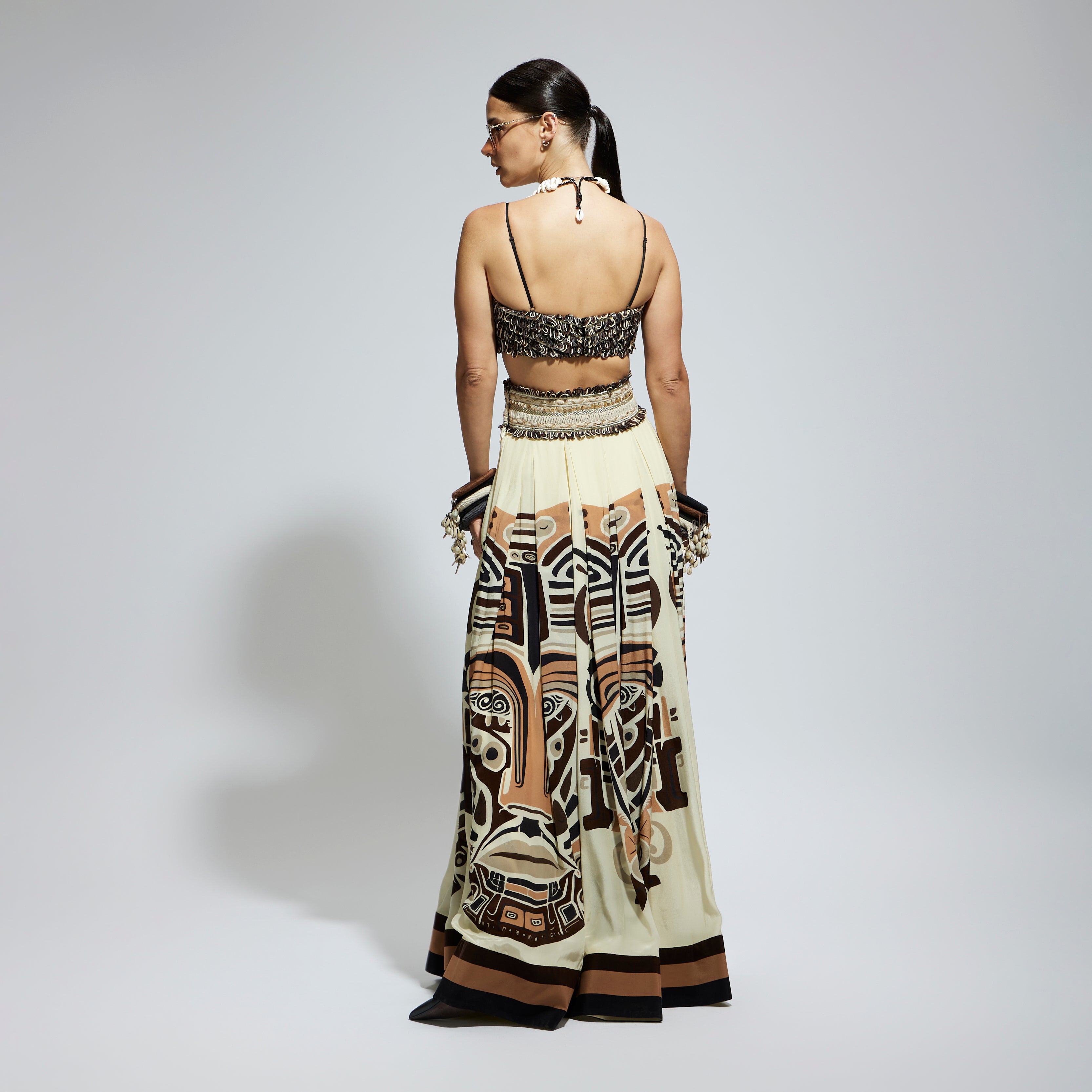 IVORY MASK PRINTED BOX PLEATED SKIRT WITH POCKETS TEAMED WITH A TEXTURED BUSTIER