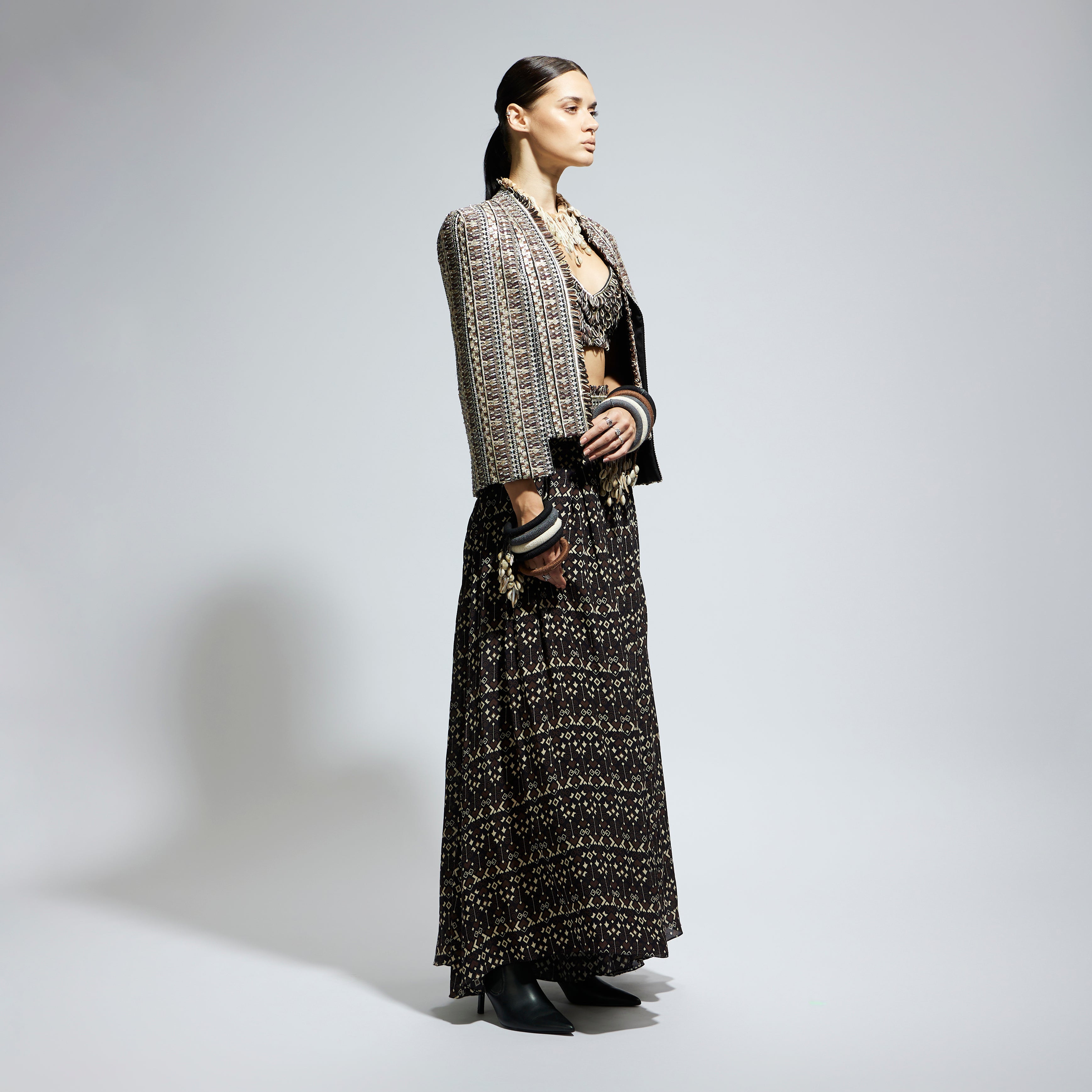 BROWN THREADWORK CAPE JACKET PAIRED WITH TEXTURED BUSTIER AND FLARED PANTS