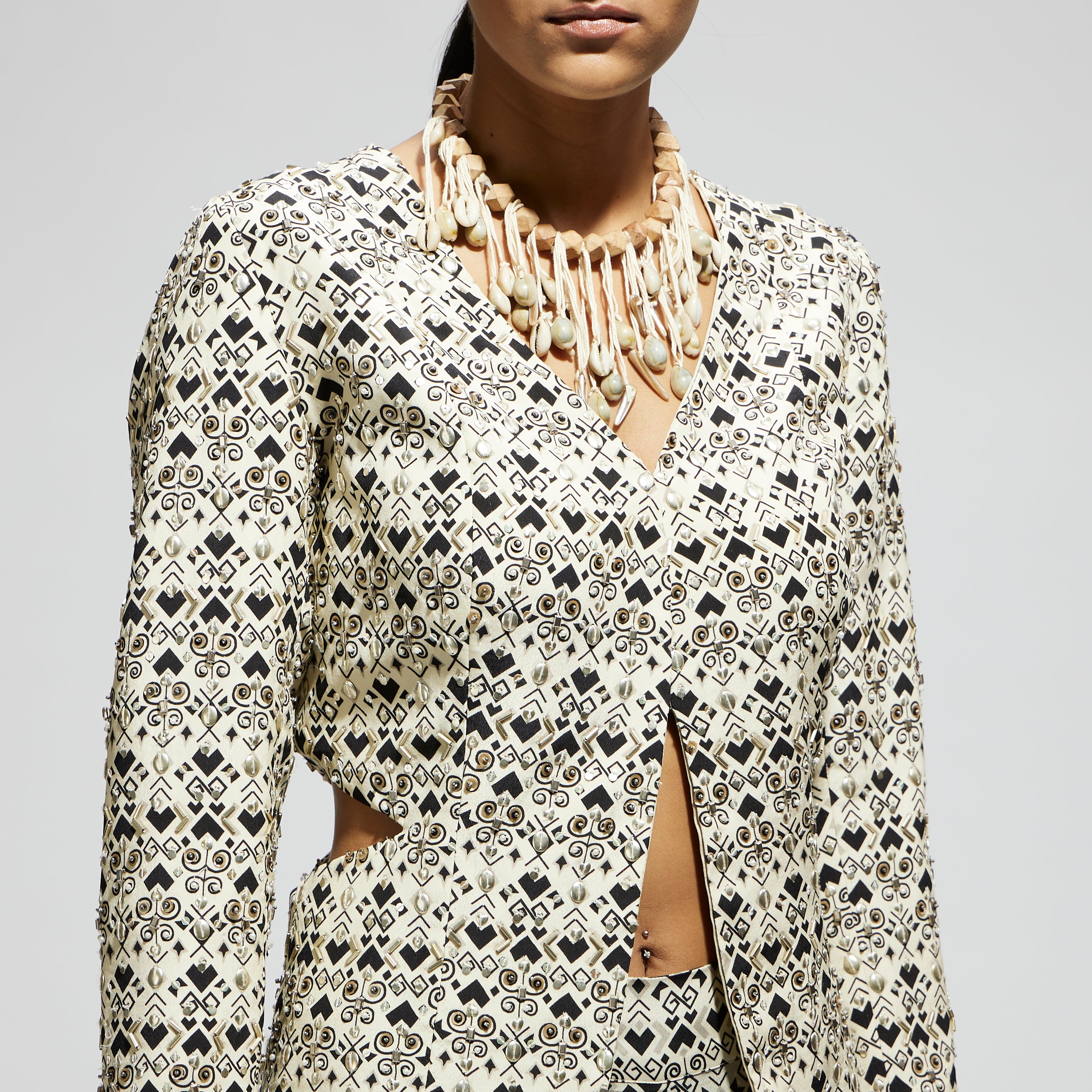 WHITE EMBELLISHED SIDE CUT OUT JACKET WITH PRINTED FLARED PANTS