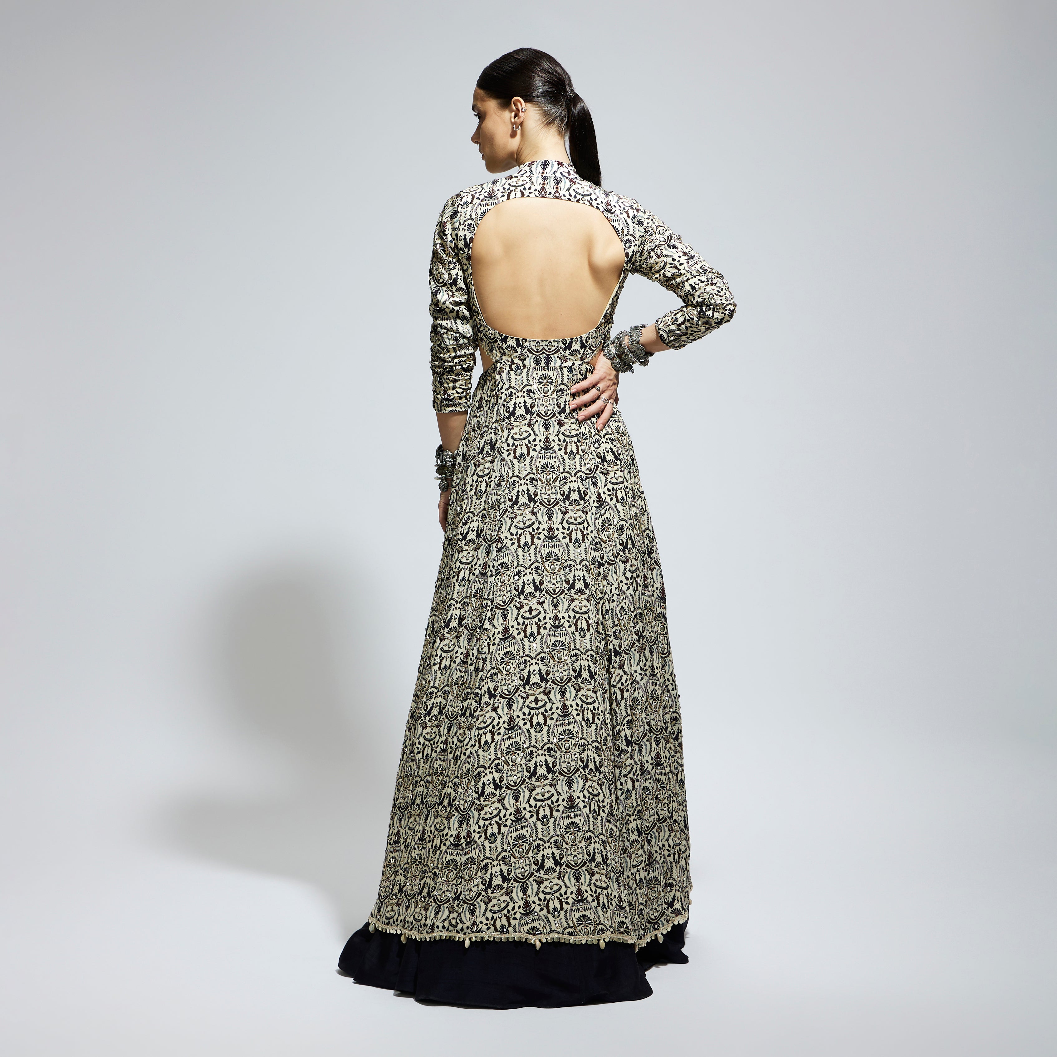 SAMSARA: WHITE HEAVILY EMBELLISHED WAIST CUT OUT JACKET PAIRED WITH A MIDNIGHT BLUE LEHENGA