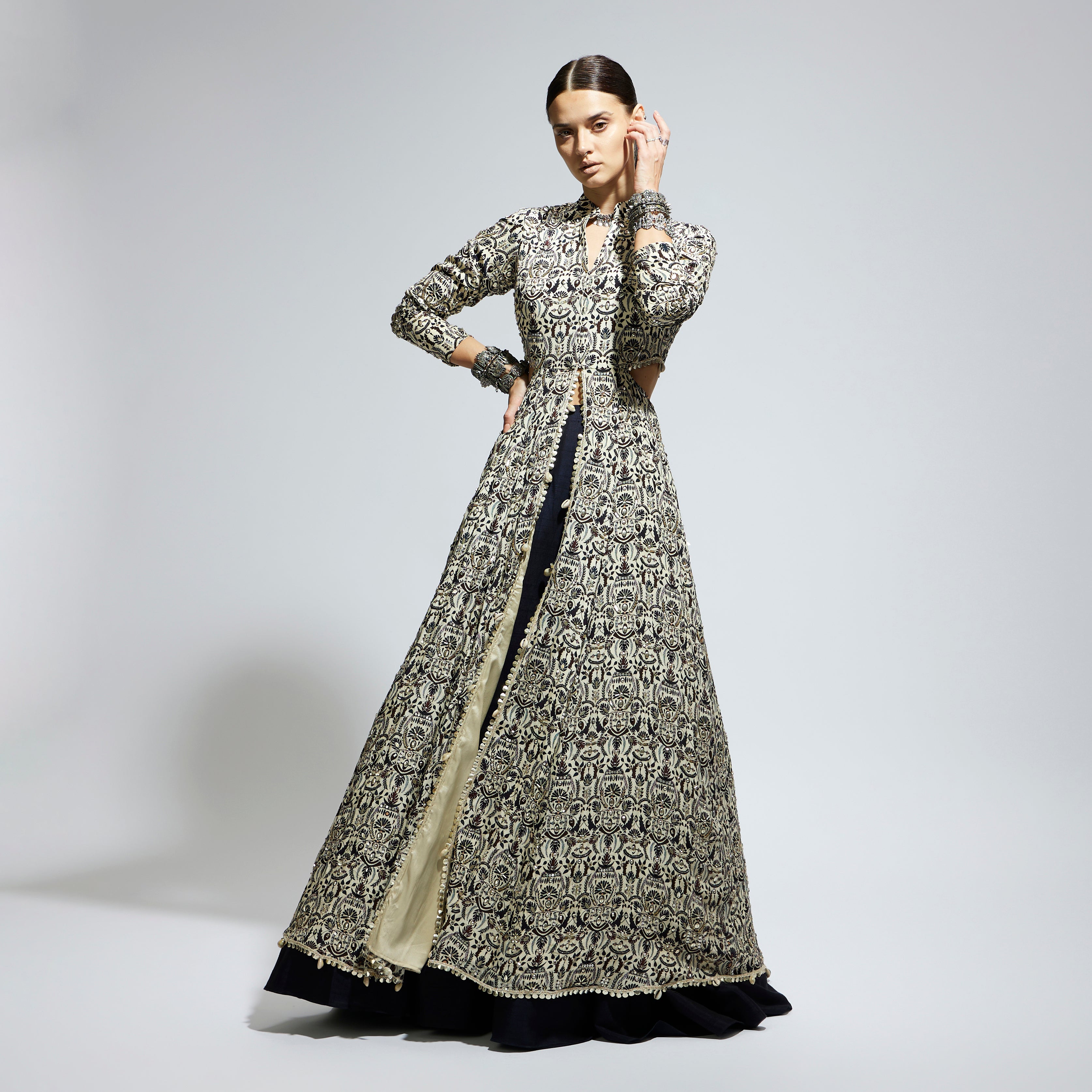 SAMSARA: WHITE HEAVILY EMBELLISHED WAIST CUT OUT JACKET PAIRED WITH A MIDNIGHT BLUE LEHENGA