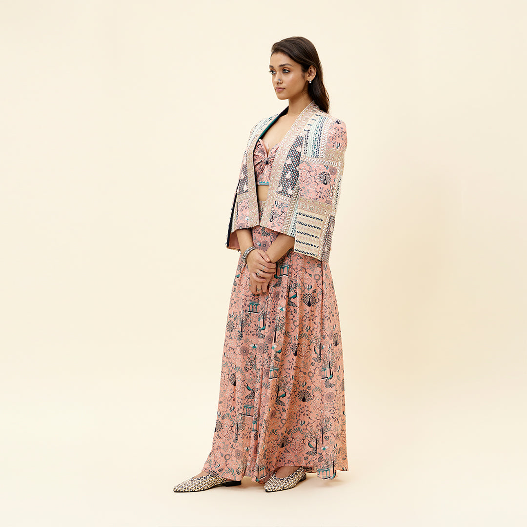 PINK MOR JAAL PRINT BIKINI BUSTIER TEAMED WITH BOX PLEATED PANTS AND A PATCHWORK NOOR CAPE JACKET