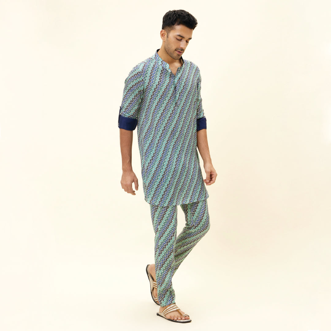 BEIGE LEAF PRINT SHORT SHIRT STYLE KURTA WITH ROLLED UP SLEEVES WITH BEIGE LEAF PRINT PANTS