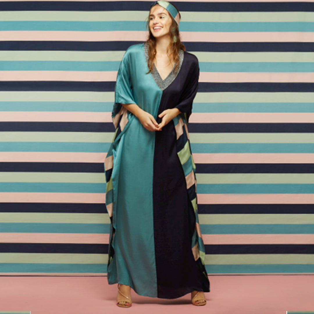 TEAL & MIDNIGHT BLUE HALF N HALF KAFTAN WITH A
GALEECHA TEXTURED NECKLINE, FINISHED WITH A BOLD
STRIPED LINING.