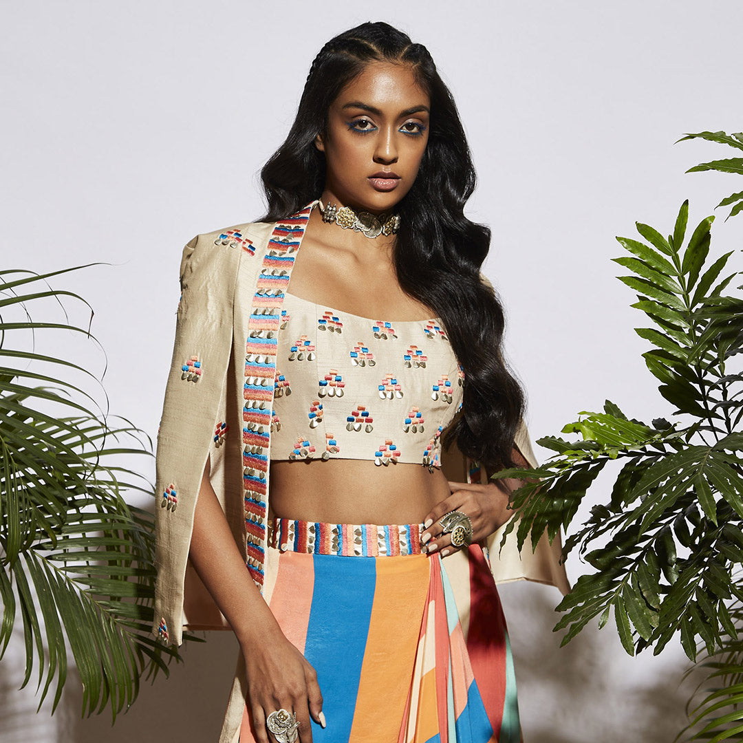 STRIPE PRINT DRAPE SKIRT WITH BUTTIE EMBROIDERED BUSTIER AND BEIGE SHORT STRUCTURED JACKET